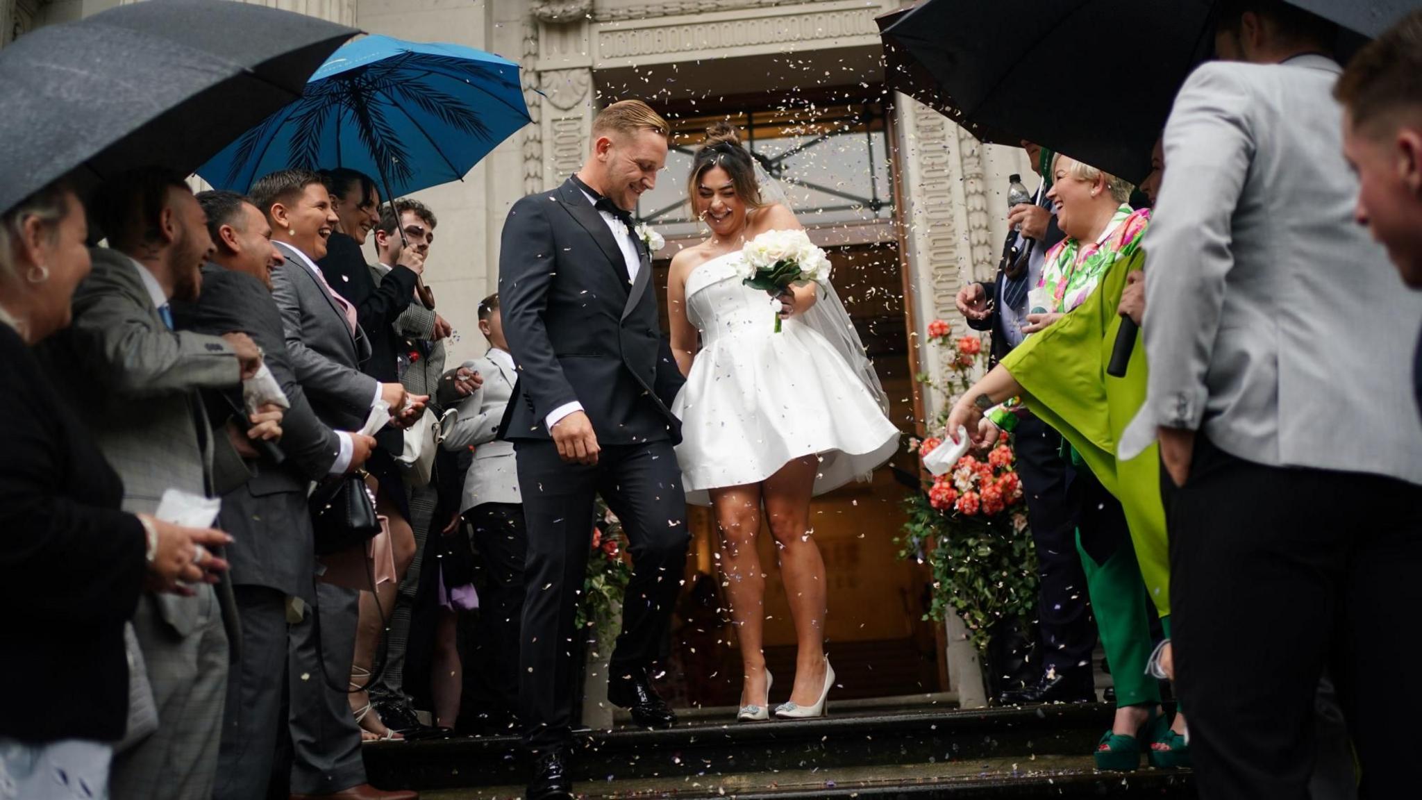 Newly married couple Jack and Katie Webster walk down the steps at Old Marylebone Town Hall