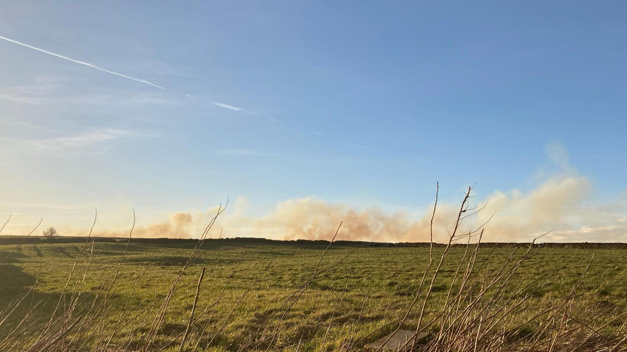 Moorland with smoke on the horizon