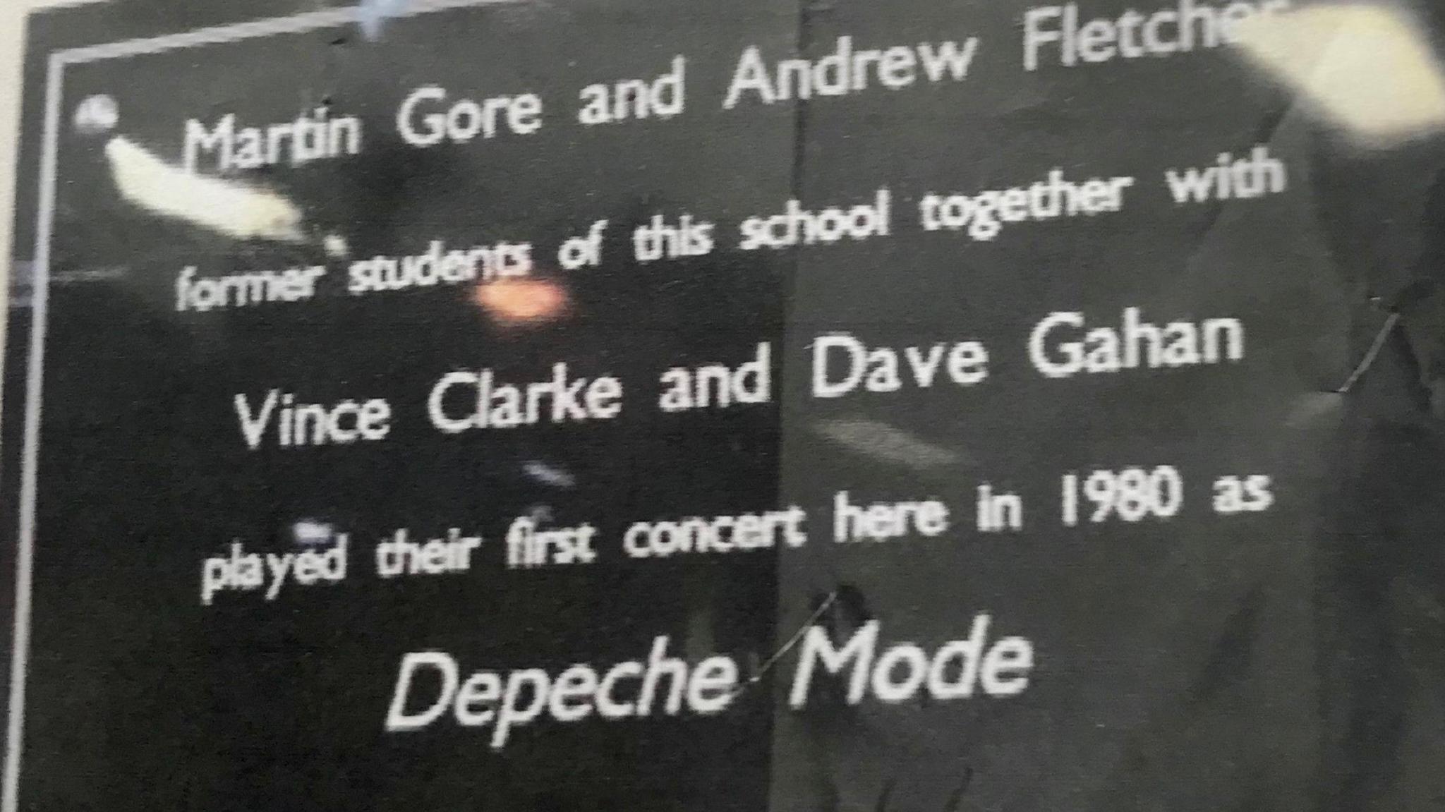 A black shiny plaque says: Martin Gore and Andrew Fletcher former students of this school - together with Vince Clarke and Dave Gahan - played their first concert here in 1980 as Depeche Mode.