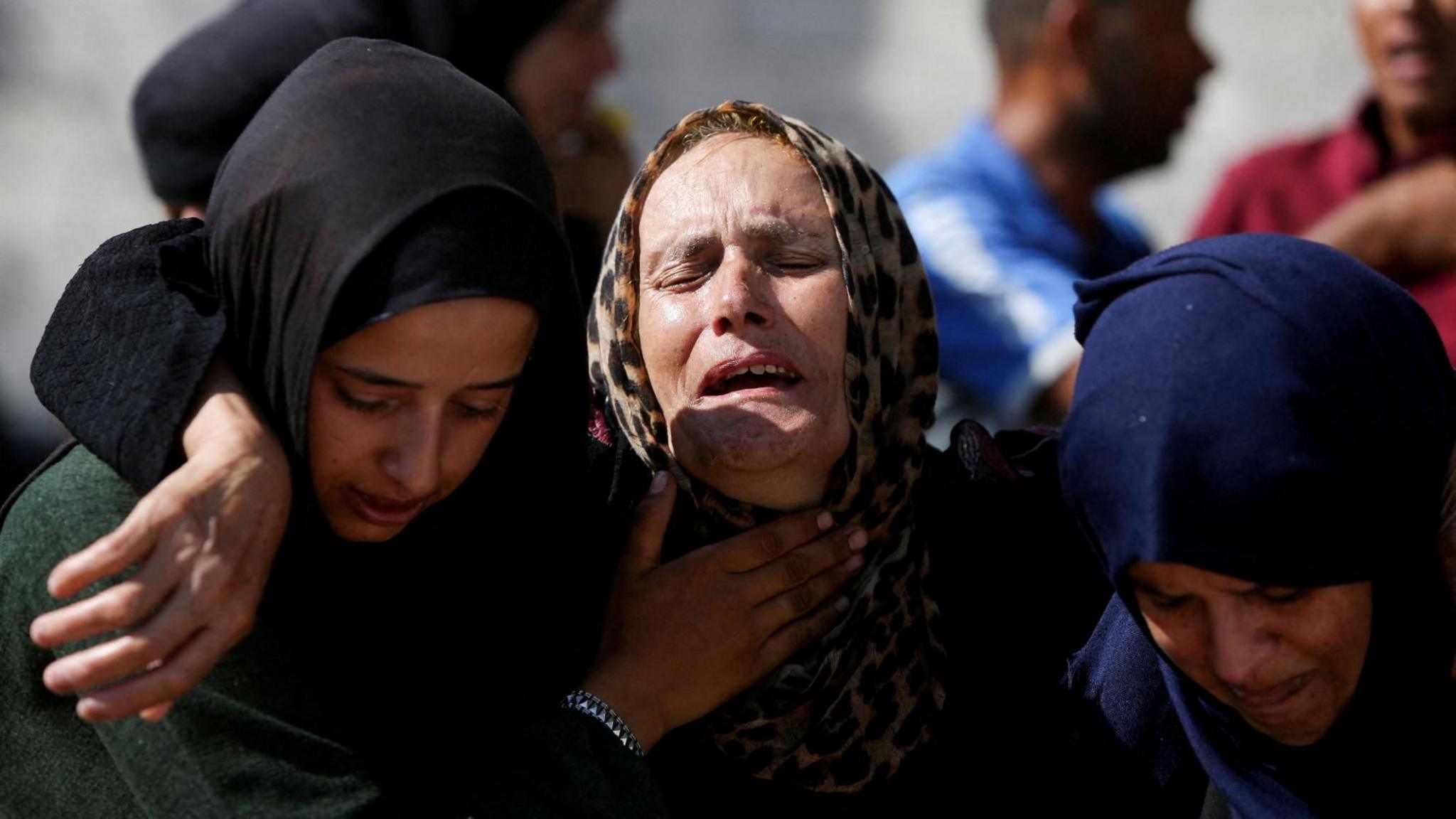 Mourners react during the funeral of Palestinians reportedly killed in an overnight Israeli strike on a tent in southern Gaza, at Nasser Hospital in Khan Younis (3 July 2025)