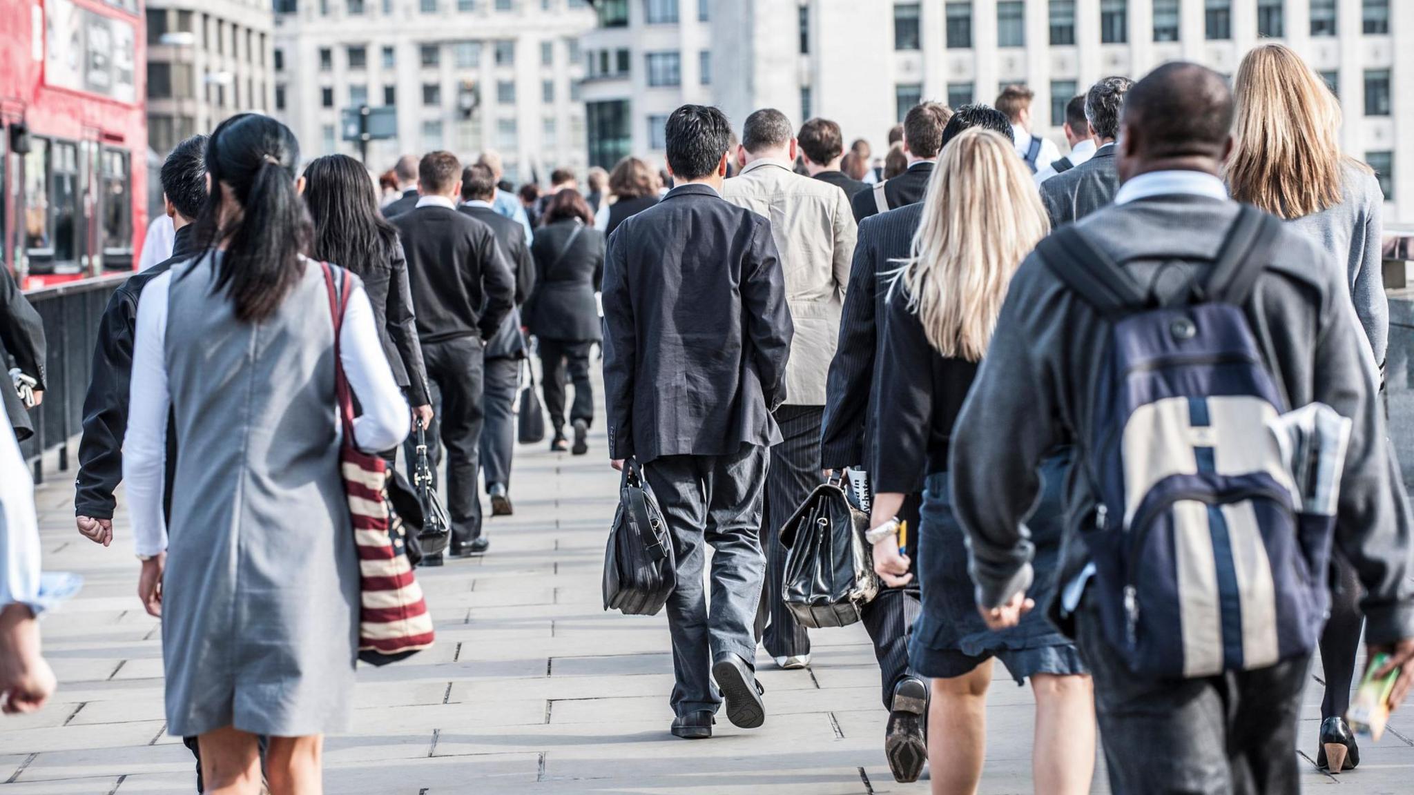 Picture of many commuters walking towards office buildings