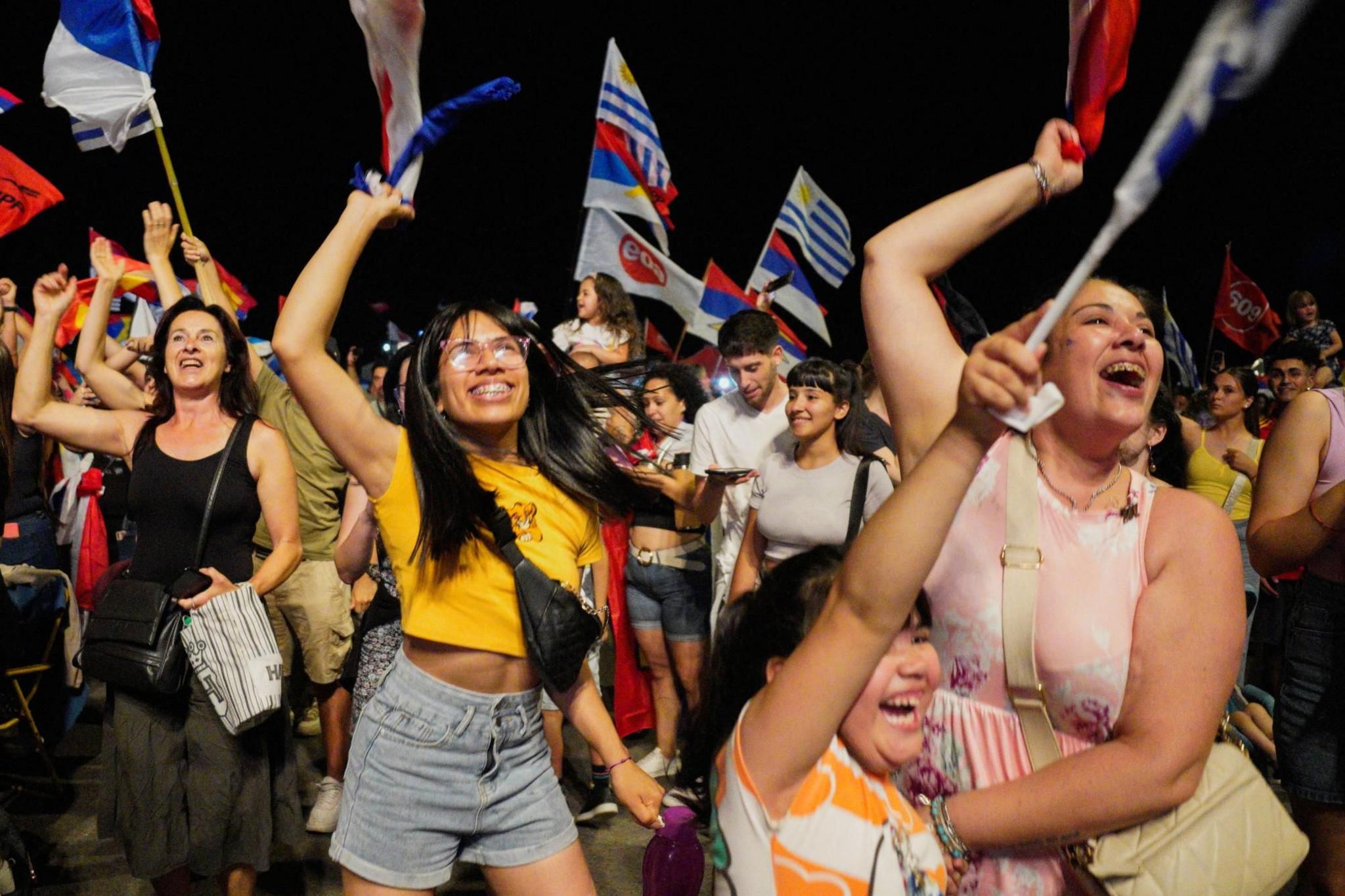 Supporters of Yamandú Orsi, centre-left presidential candidate, celebrate following early results in Uruguay's presidential election run-off 