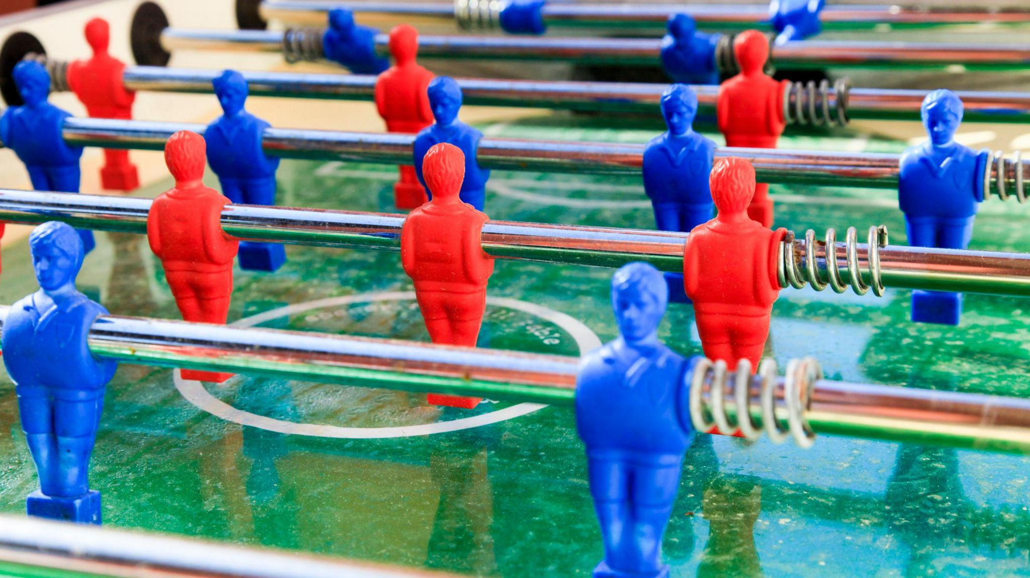 Red and blue players on a football table