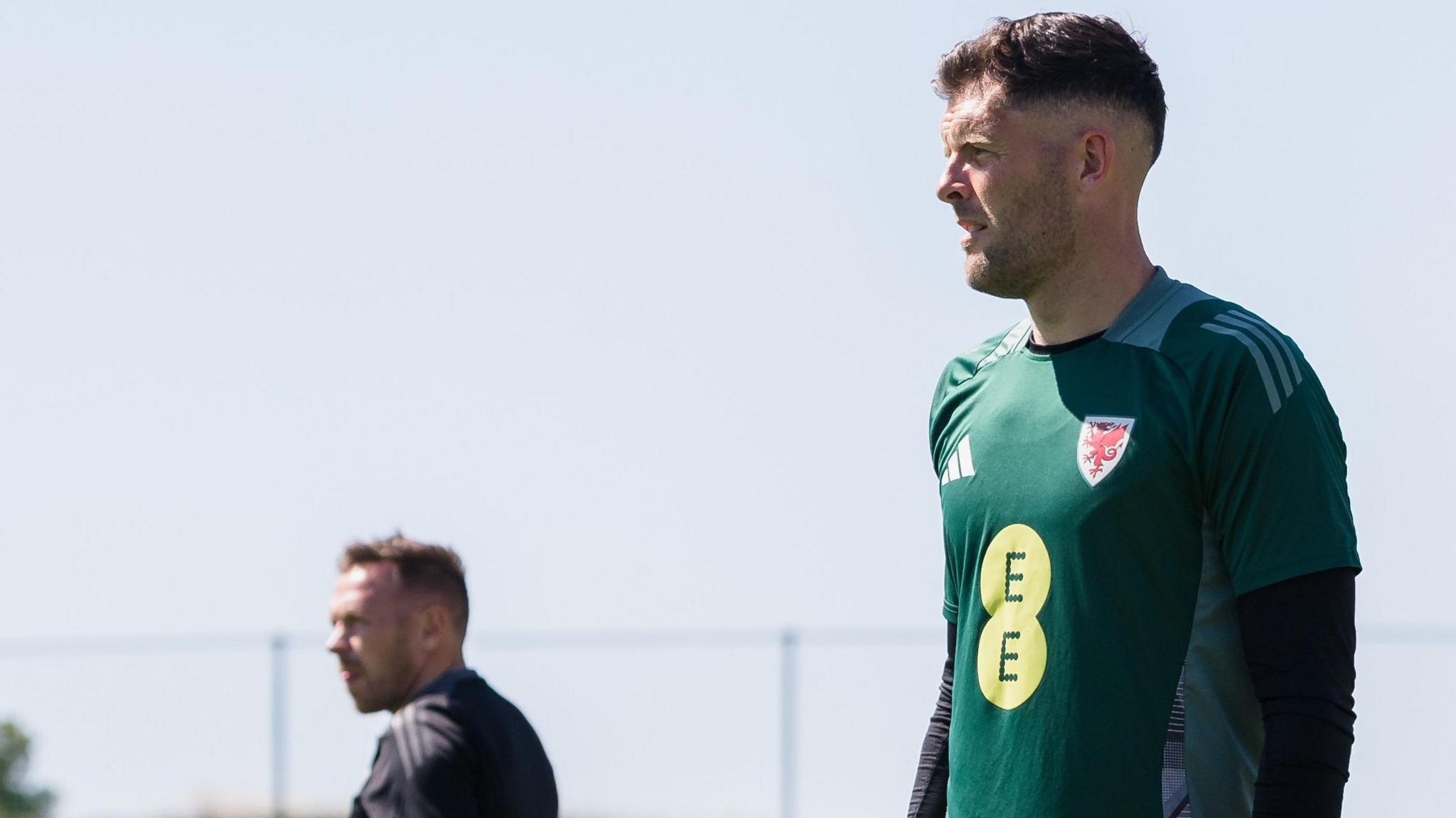 Connor Roberts (right) during Wales training in Spain with manager Craig Bellamy in the background