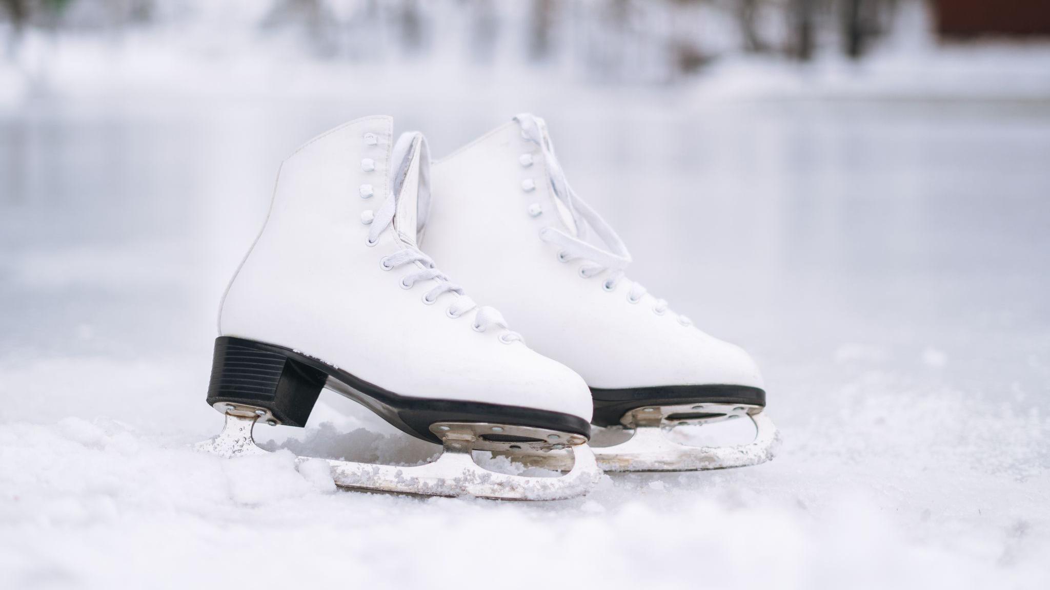 Pair of ice skates on rink 