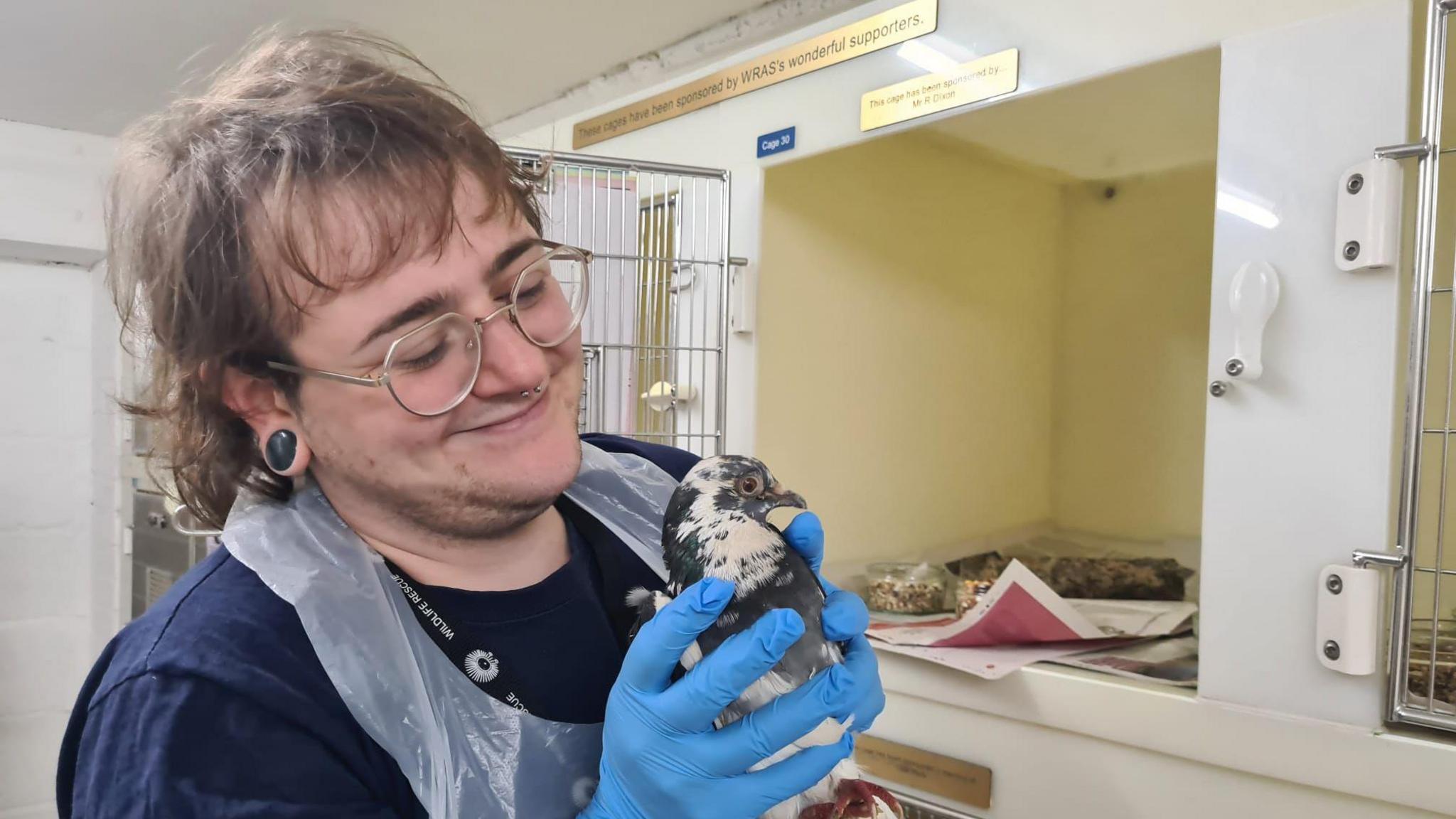 A rescuer holding a bird