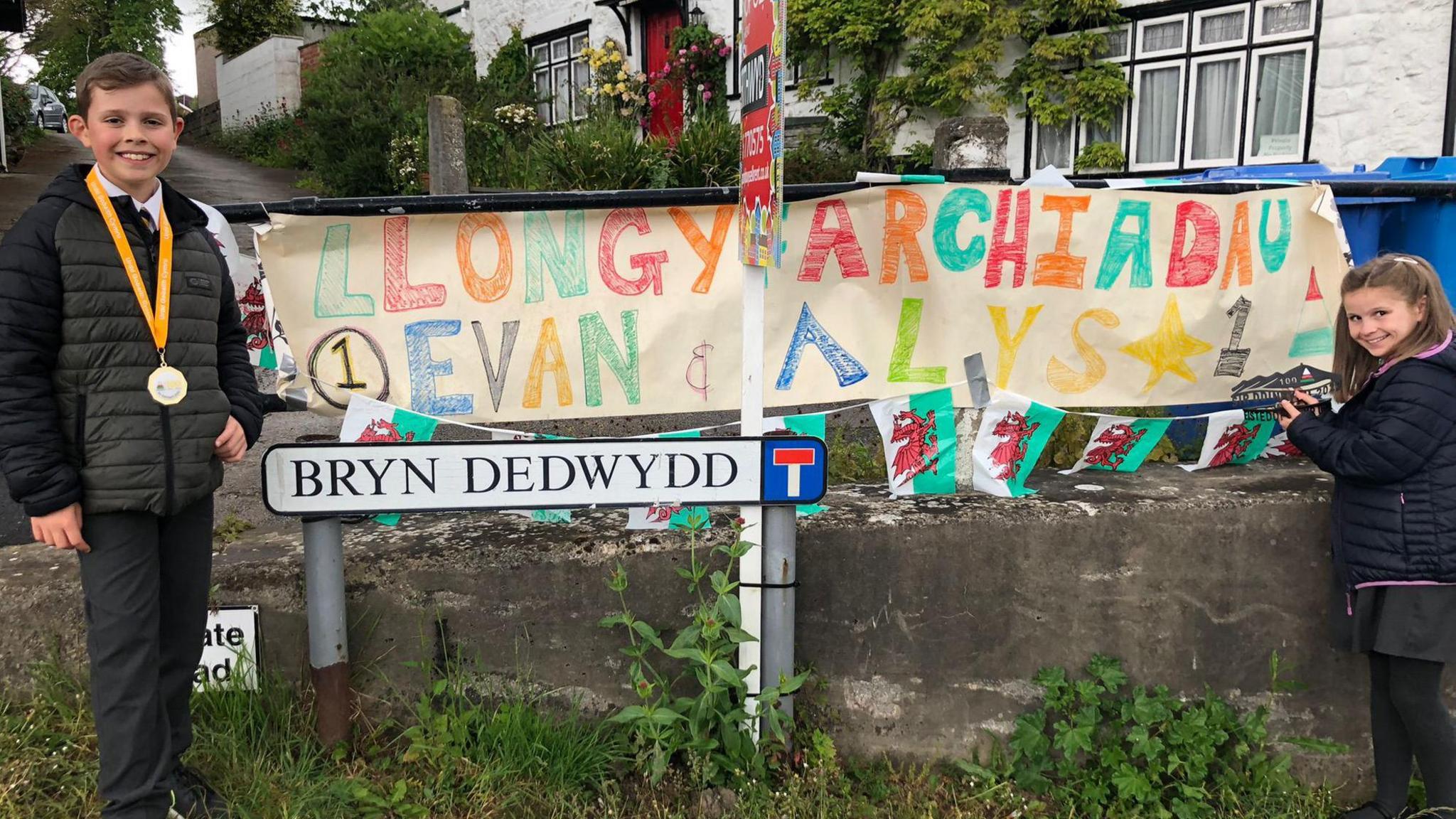 Alys and Evan holding a banner 