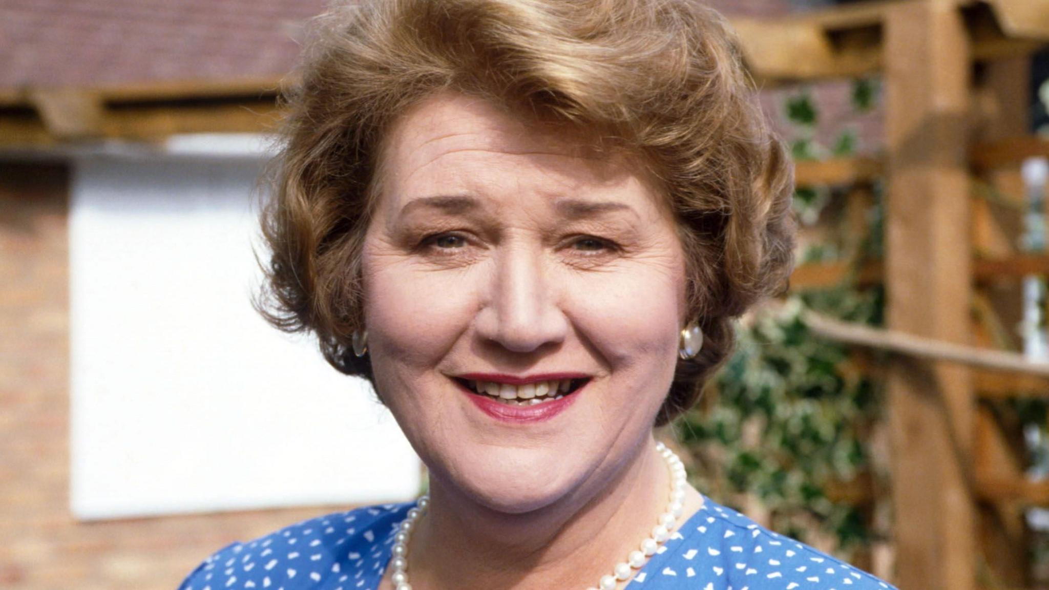 Dame Patricia Routledge smiling as Hyacinth Bucket in Keeping Up Appearances