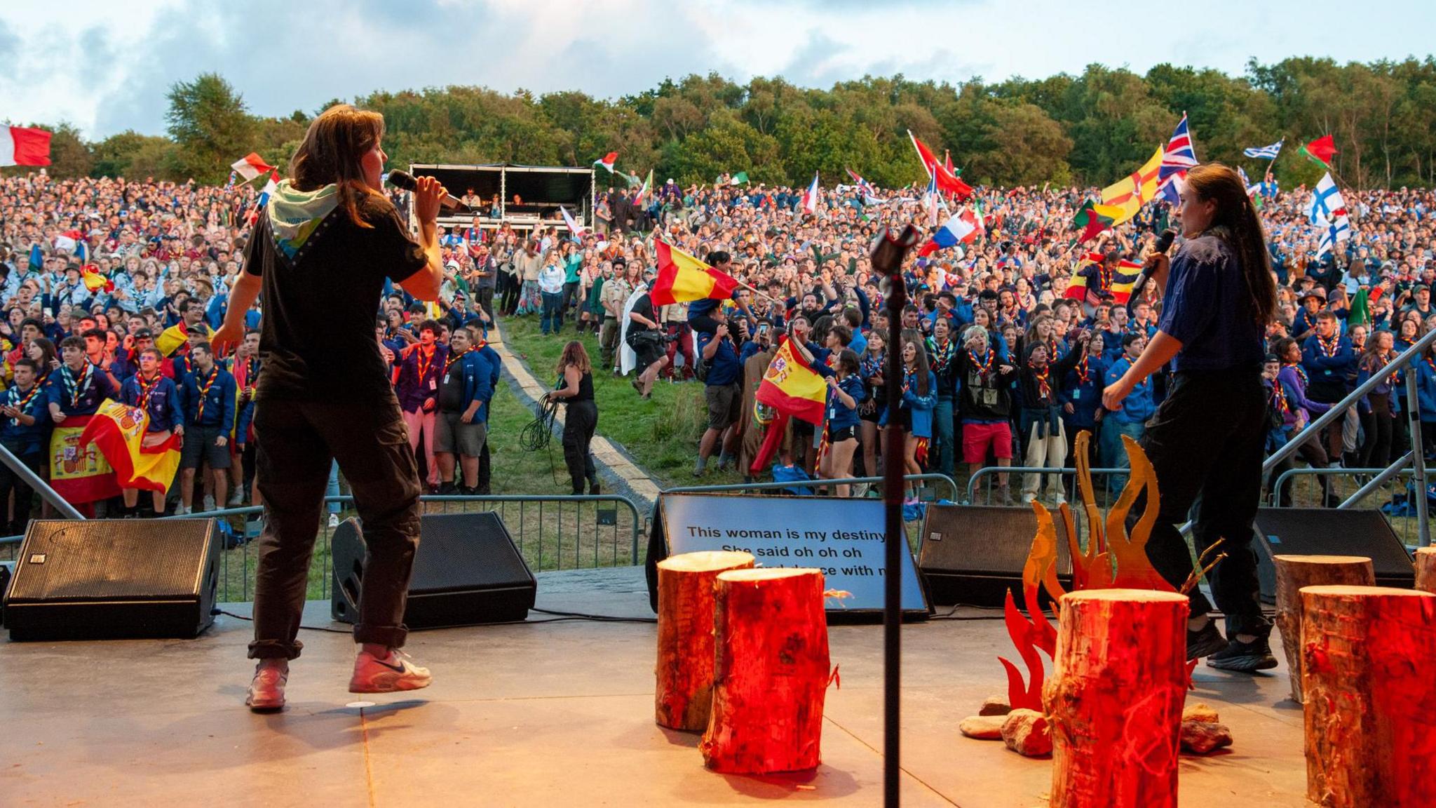 View from a stage as two leaders address thousands of scouts