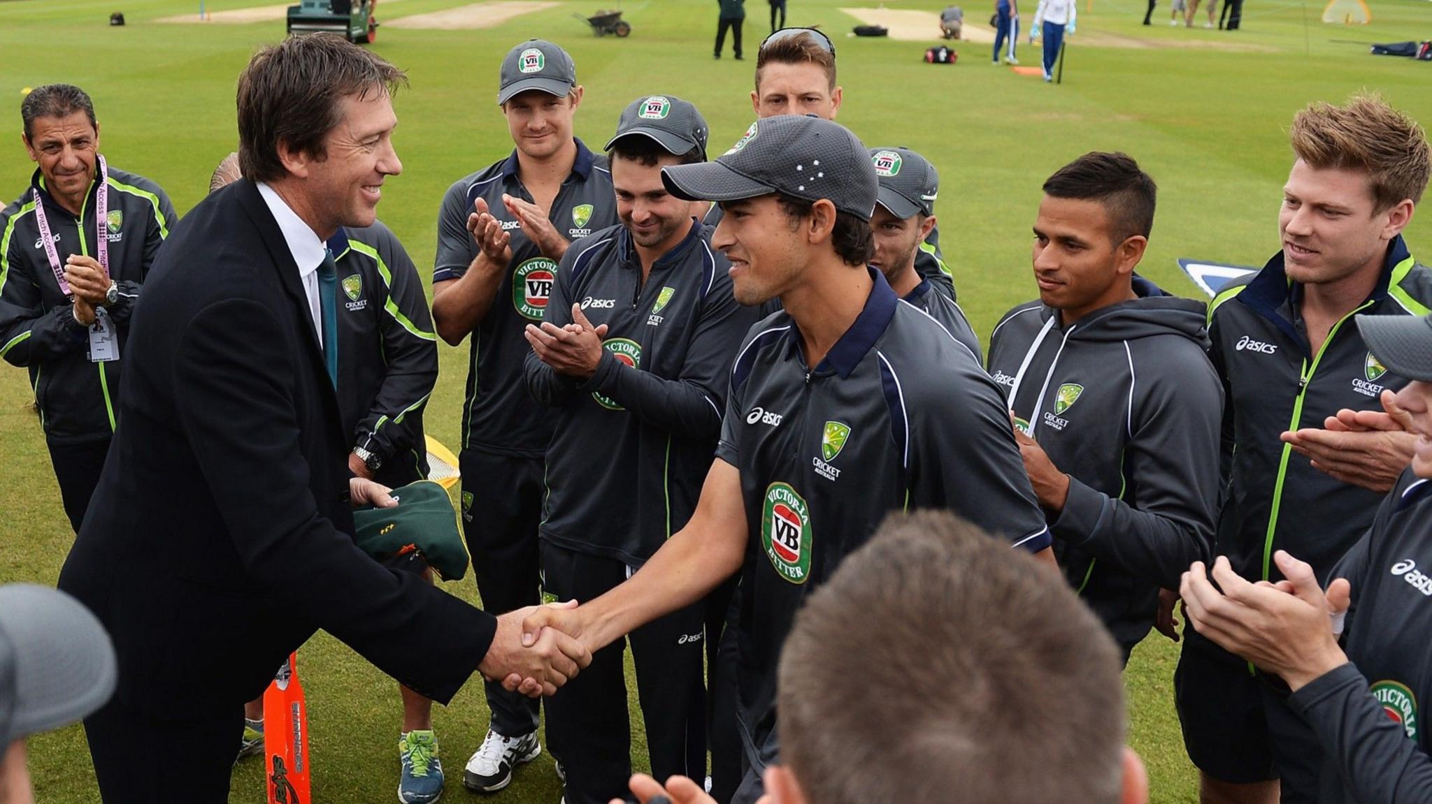 Ashton Agar shakes hands with Glenn McGrath, flanked by team-mates after being awarded his Test cap