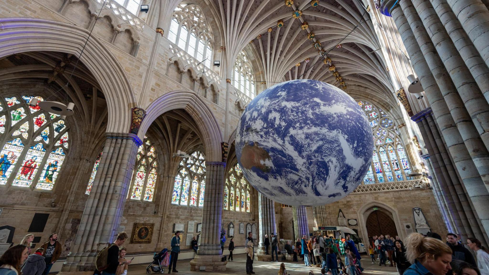 Gaia - an artwork of the Earth - suspended from the lower part of the ceiling of Exeter Cathedral. 