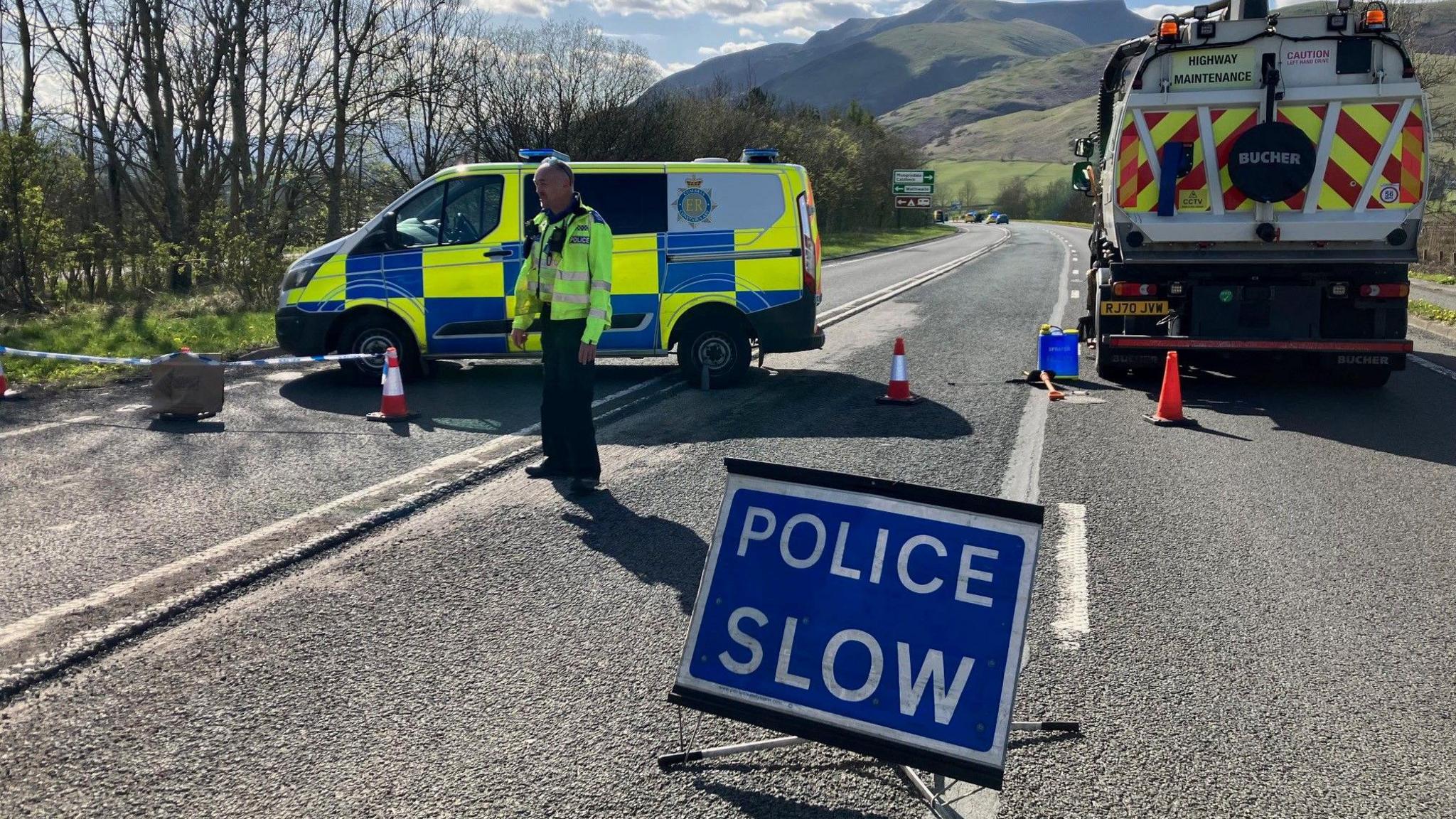 Police officer and van at the scene of the incident 