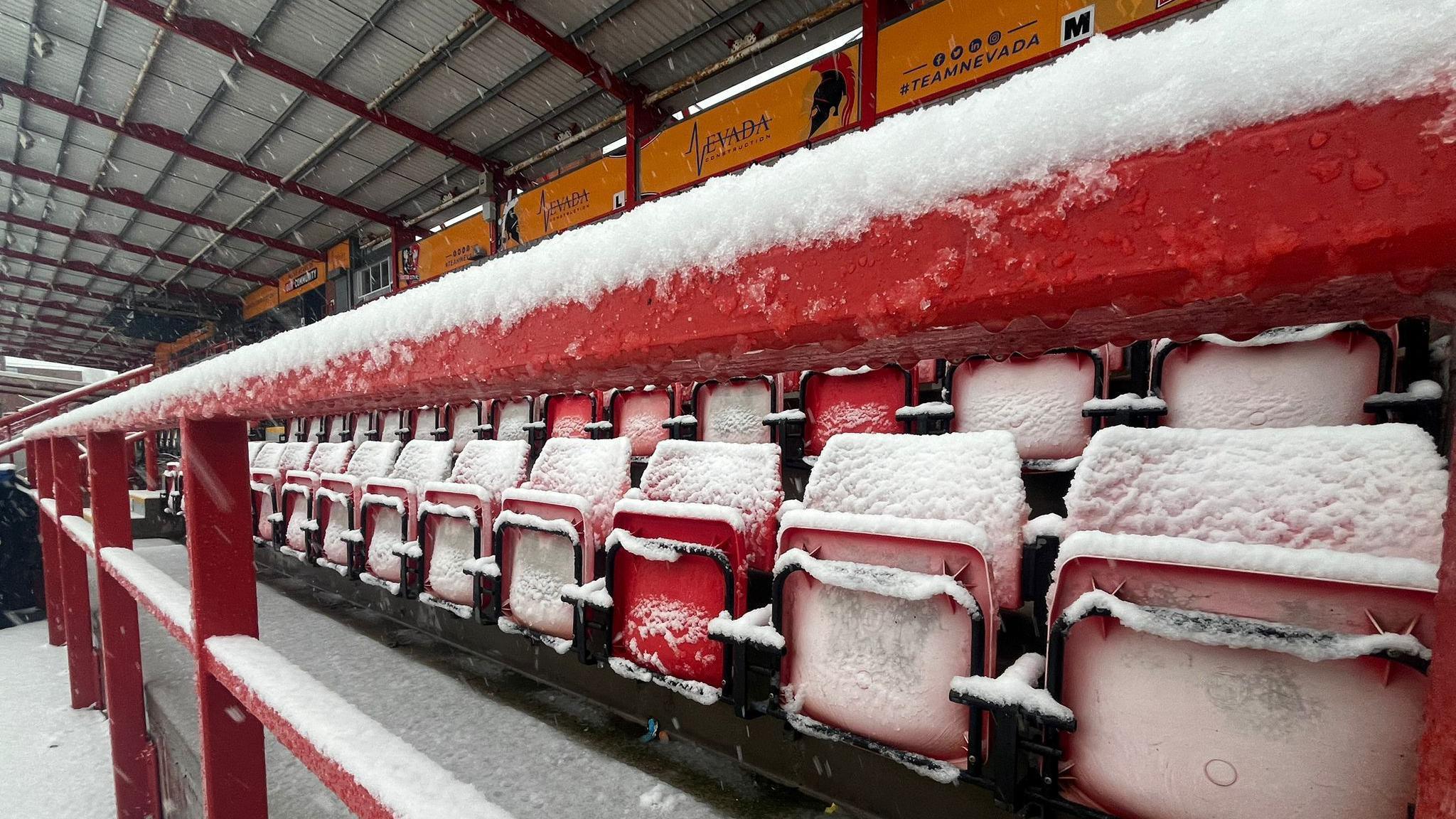 Seats at St James Park covered in snow 