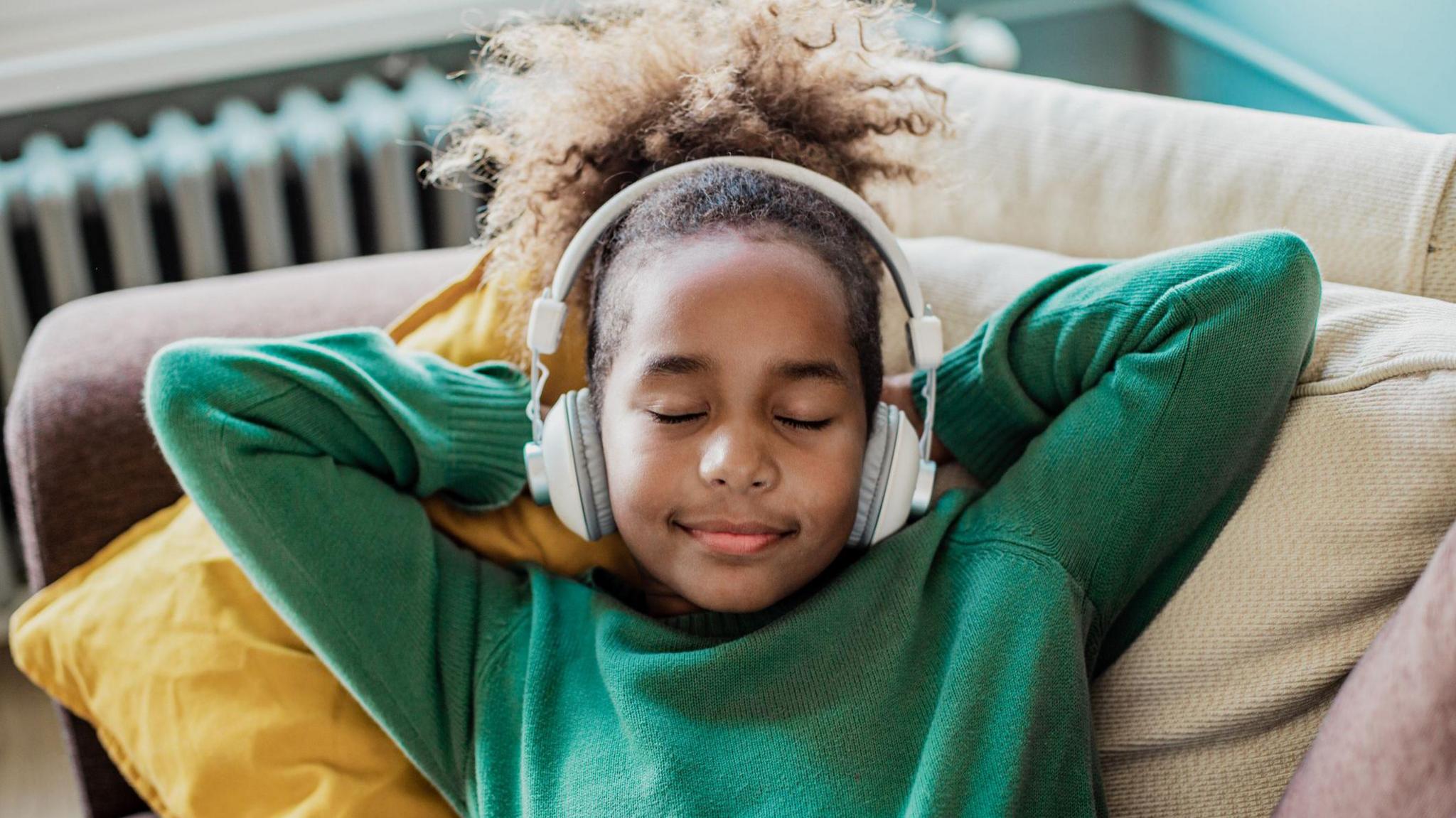 Young girl listening to audio. 