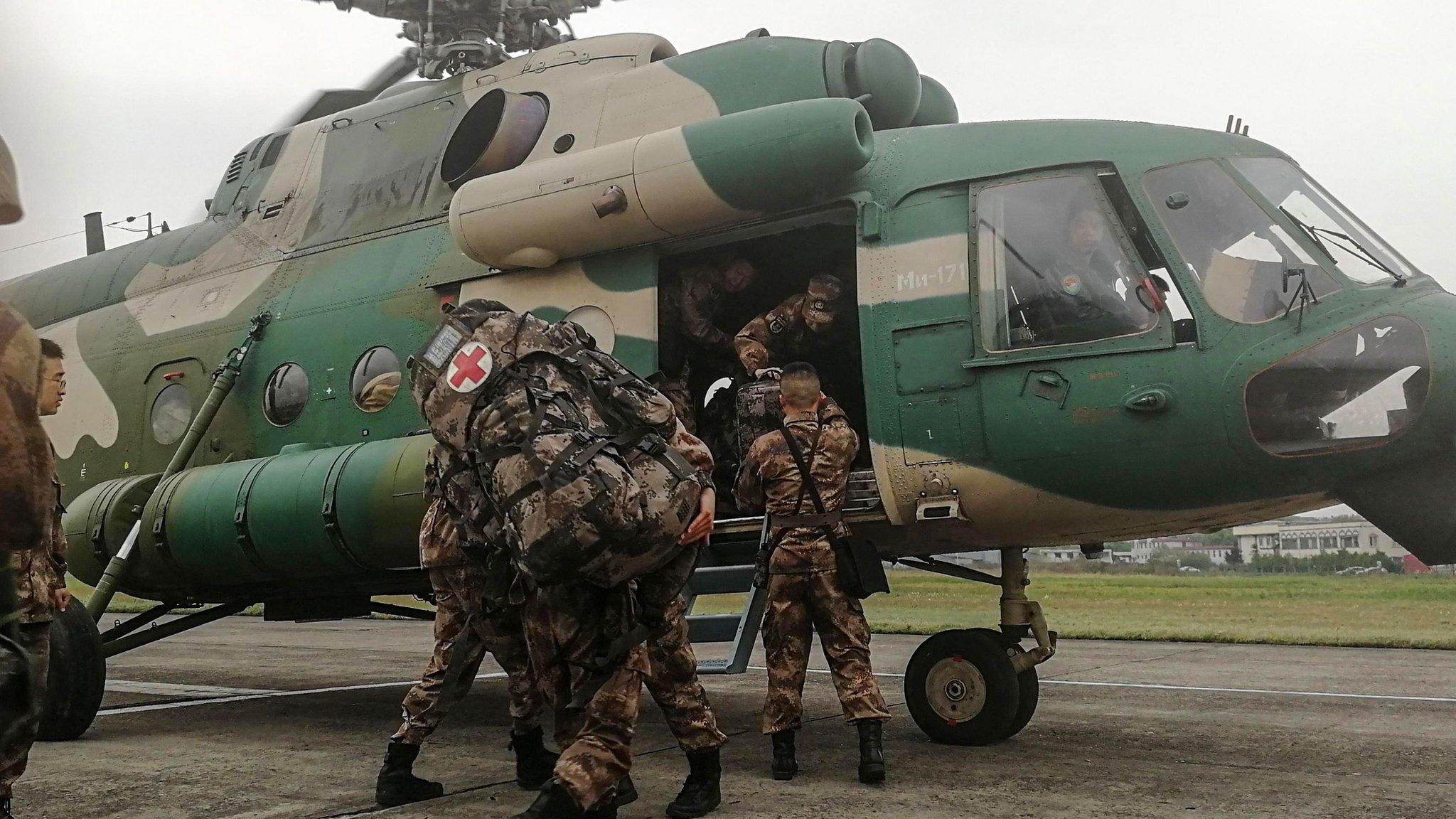 Chinese soldiers board a helicopter in Chengdu in Sichuan province on April 1, 2019, as they prepare to rescue firefighters trapped by a forest blaze in Muli county