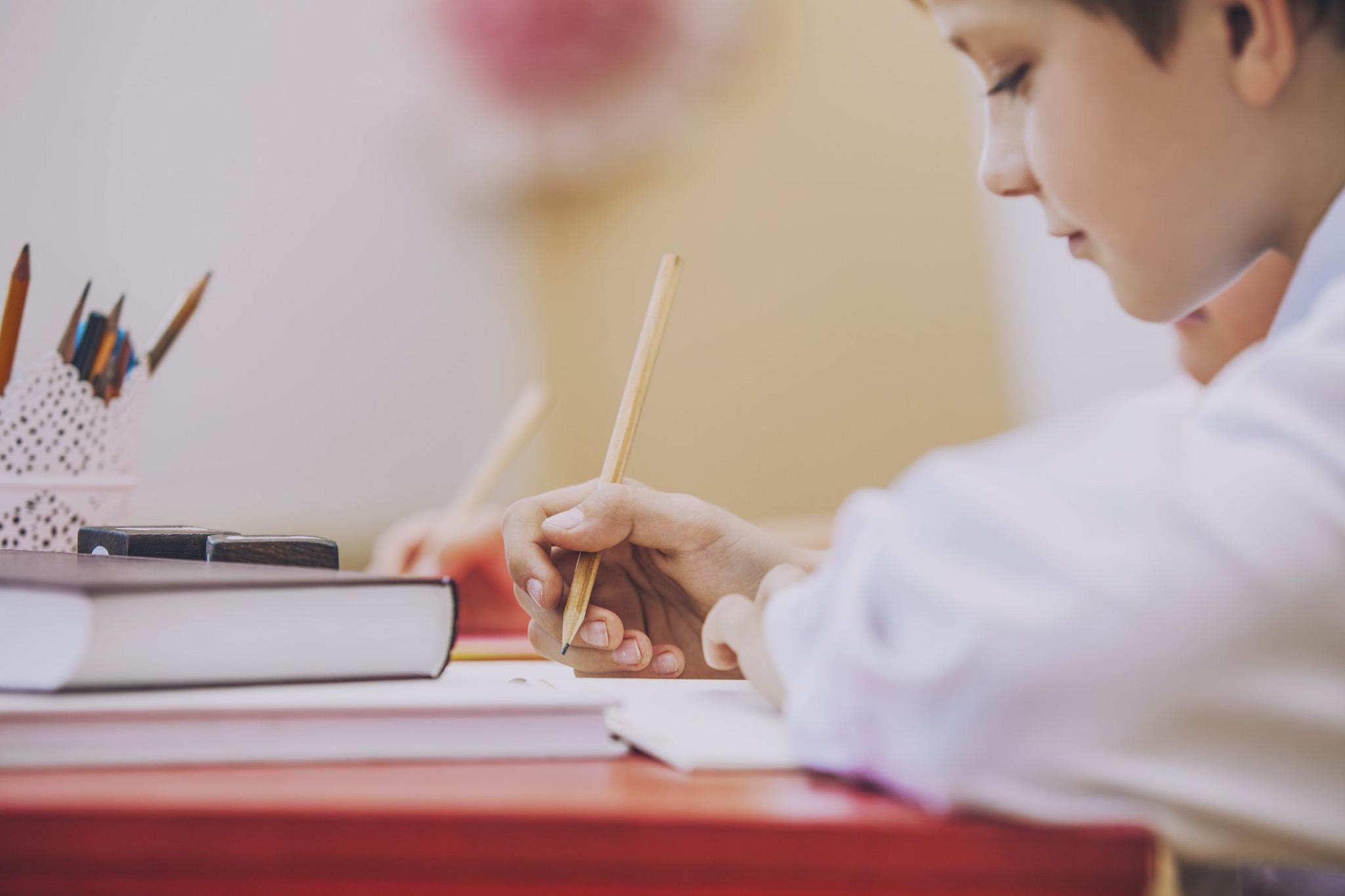 boy-writing-at-a-desk