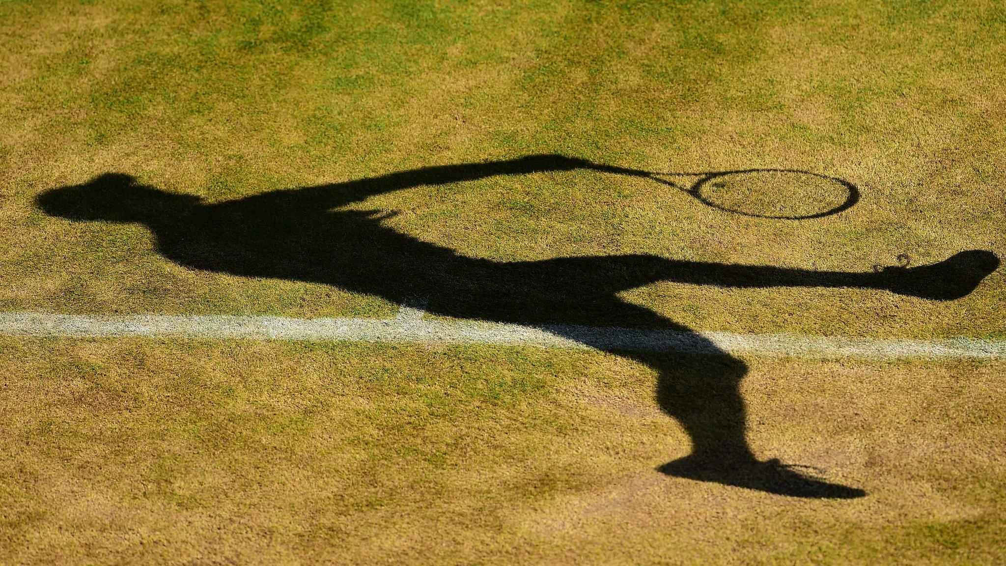 A silhouette of a tennis player