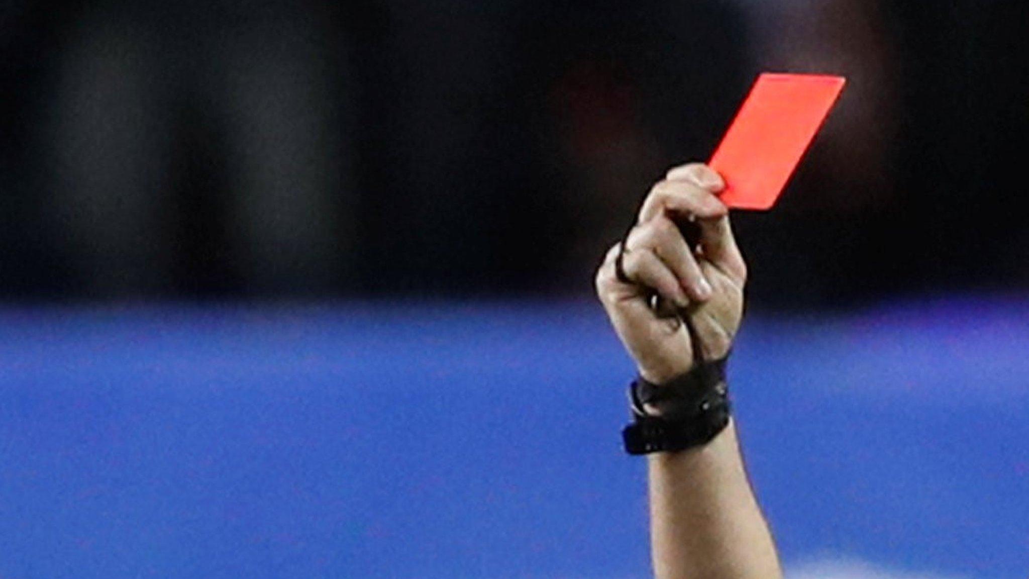 A referee showing a red card