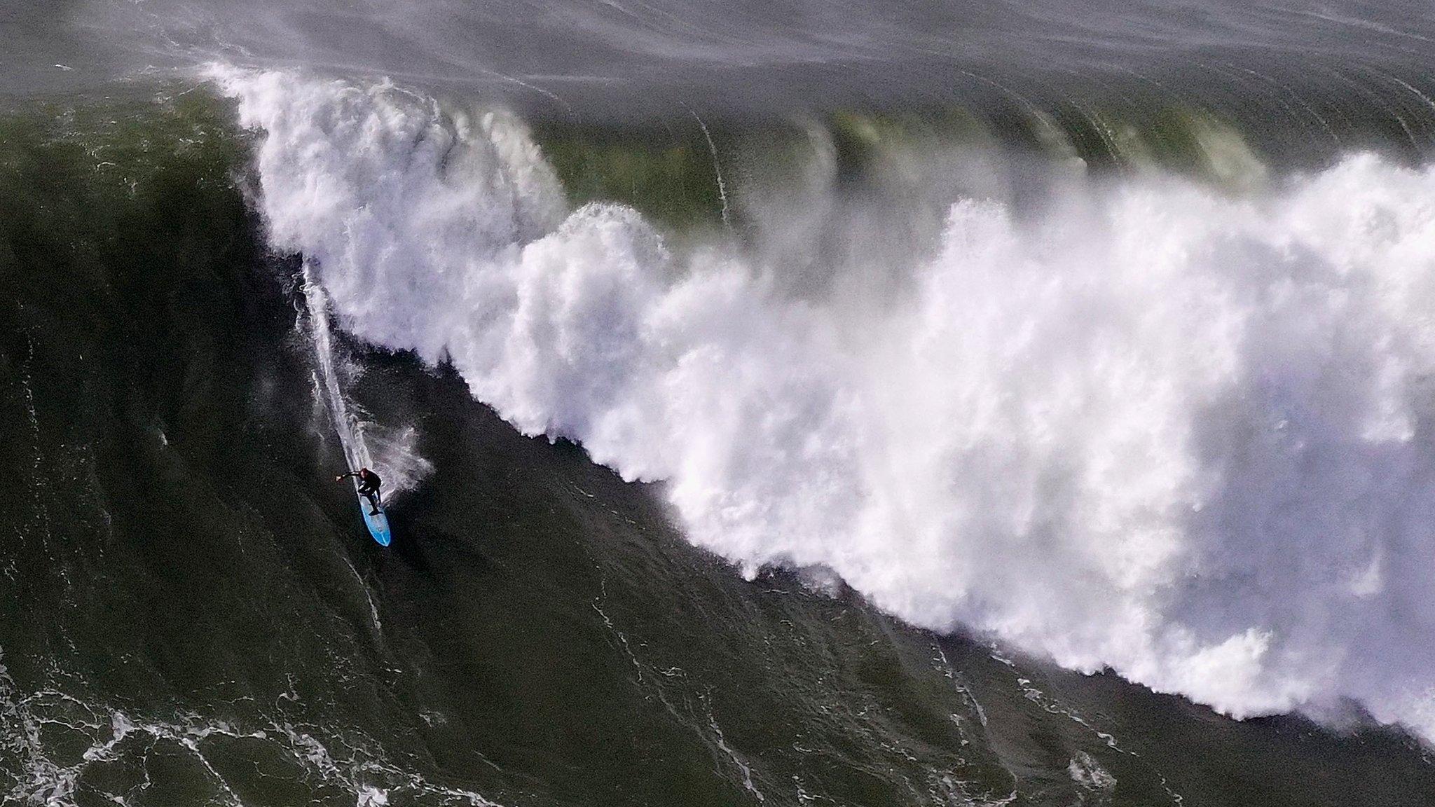 A surfer rides a wave