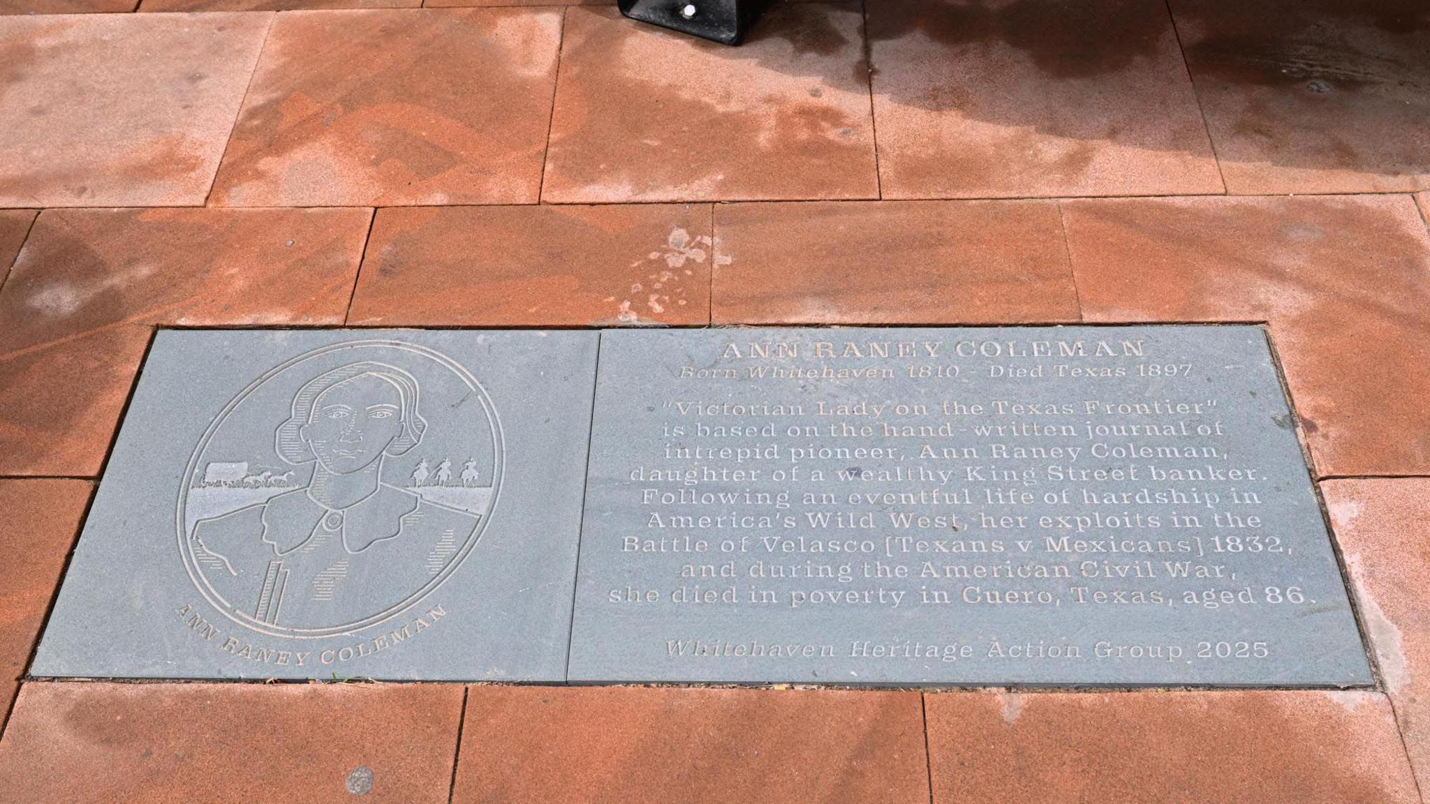 The memorial flagstone to Ann Raney Coleman made of slate and etched with image of Ann Raney and some words remembering who she was.