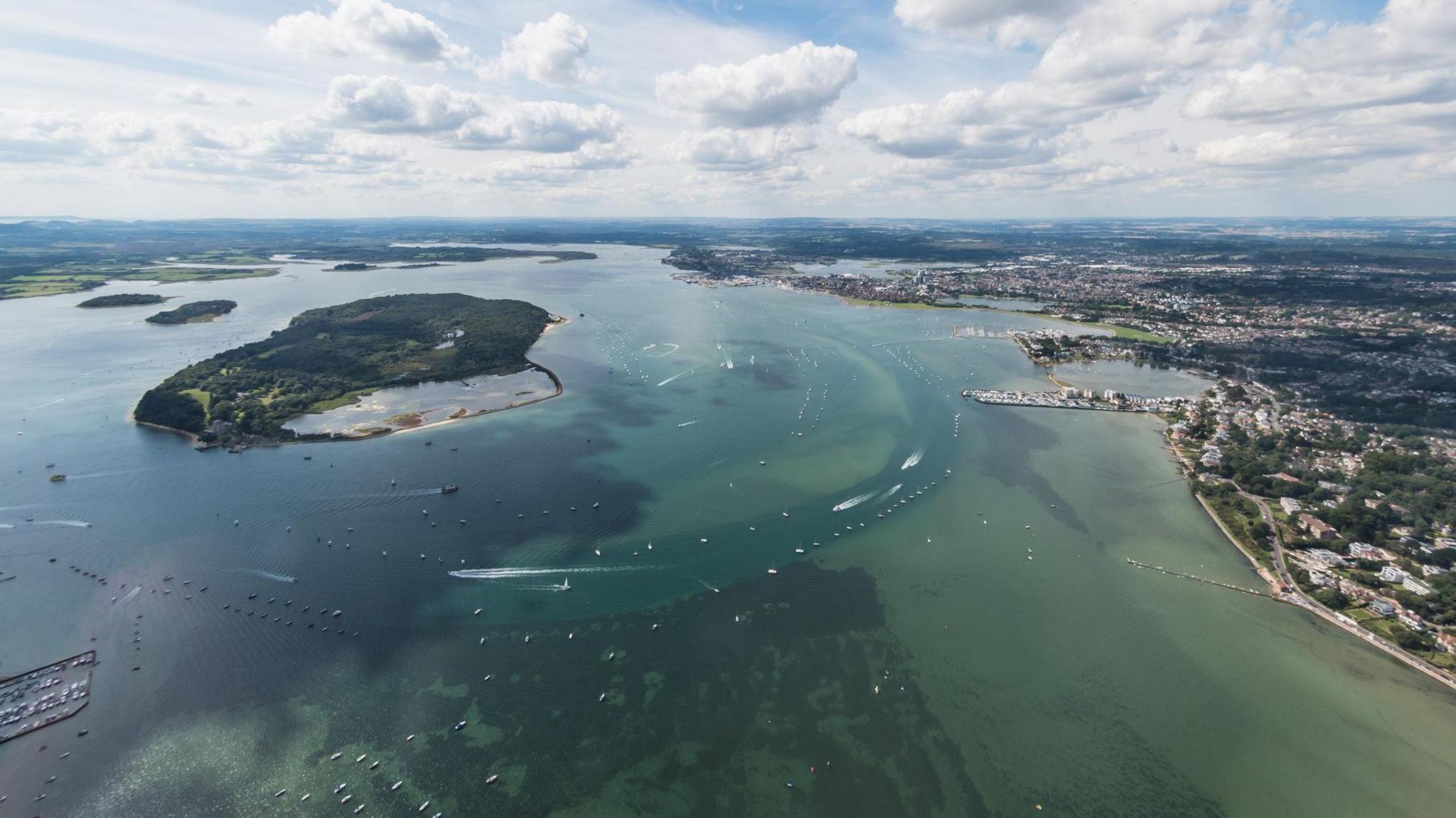 An aerial view of Brownsea Island (to the left) and Poole Harbour (to the right). 