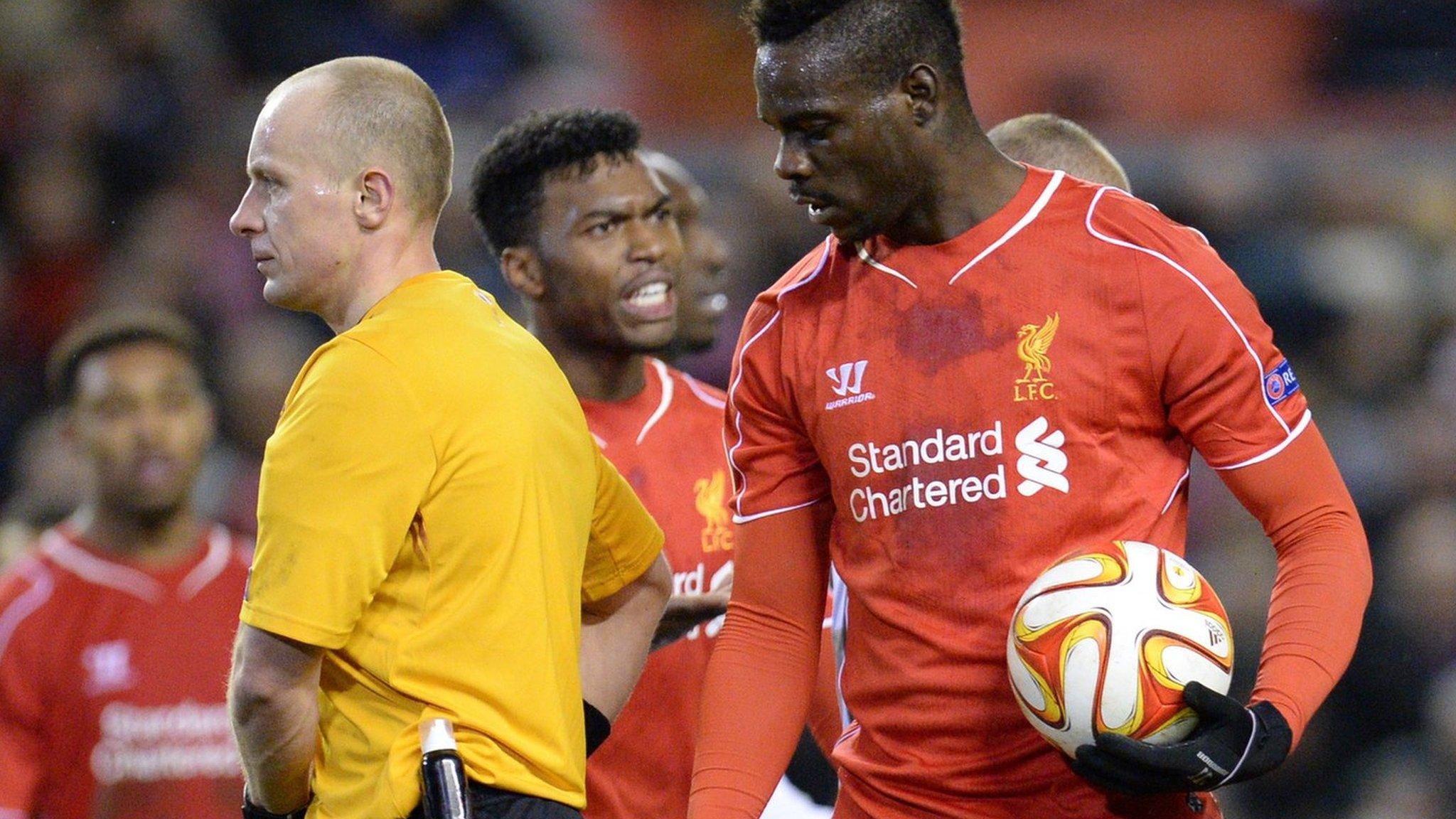 Mario Balotelli takes the ball off Jordan Henderson at a penalty