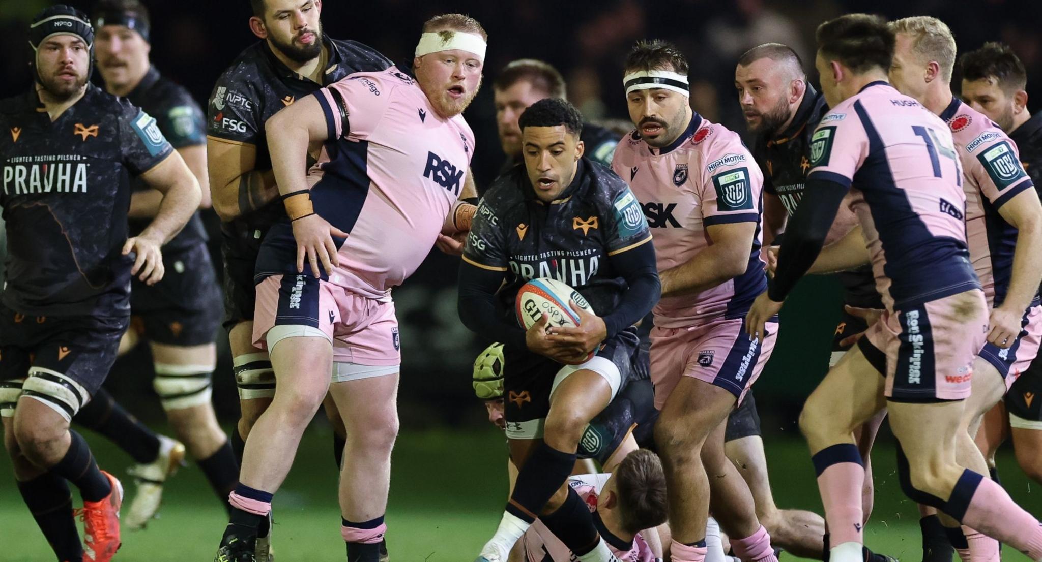 Keelan Giles of Ospreys has the ball surrounded by Cardiff players