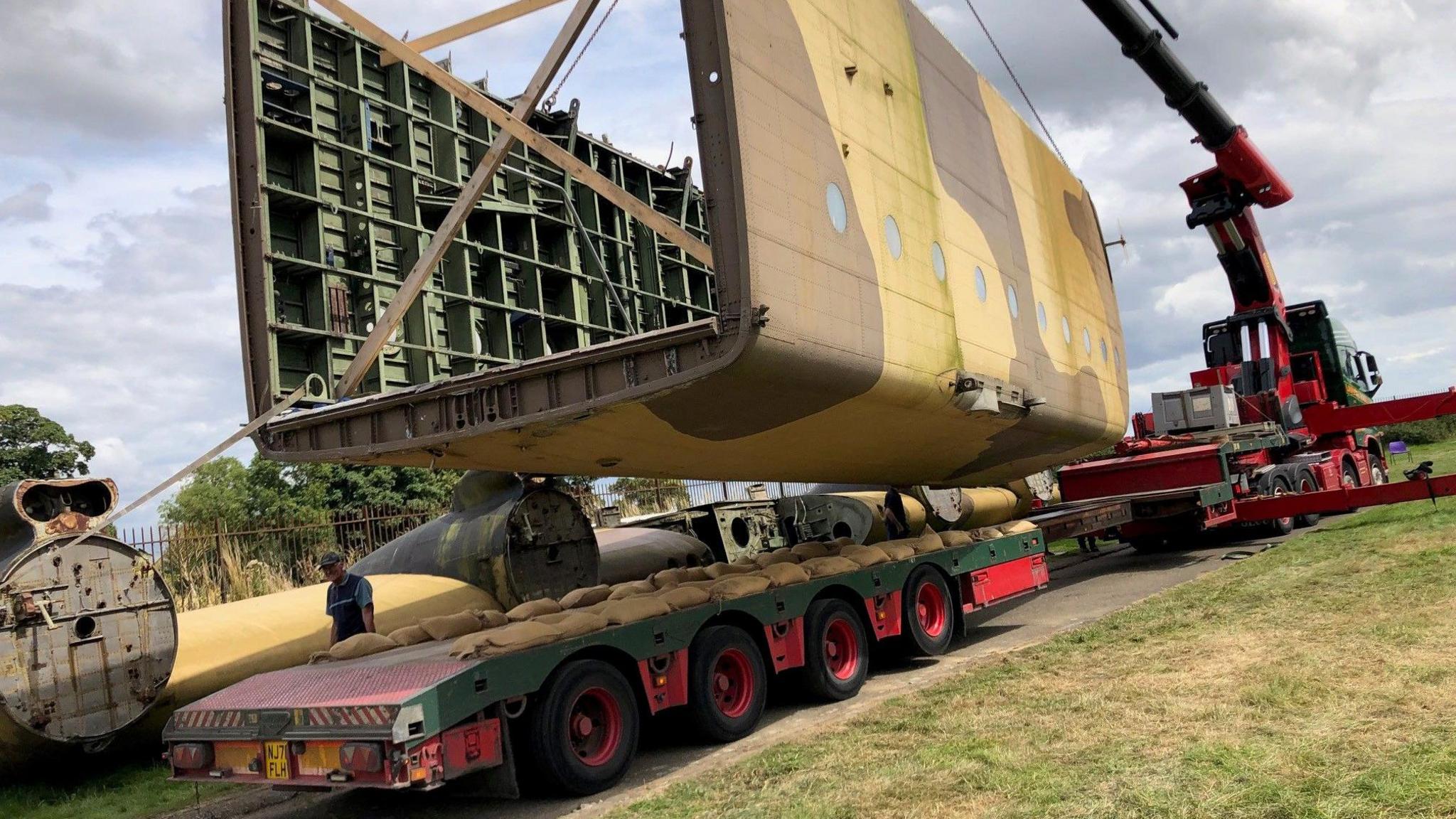 The final section of the Blackburn Beverley's fuselage being lifted onto a lorry by crane.