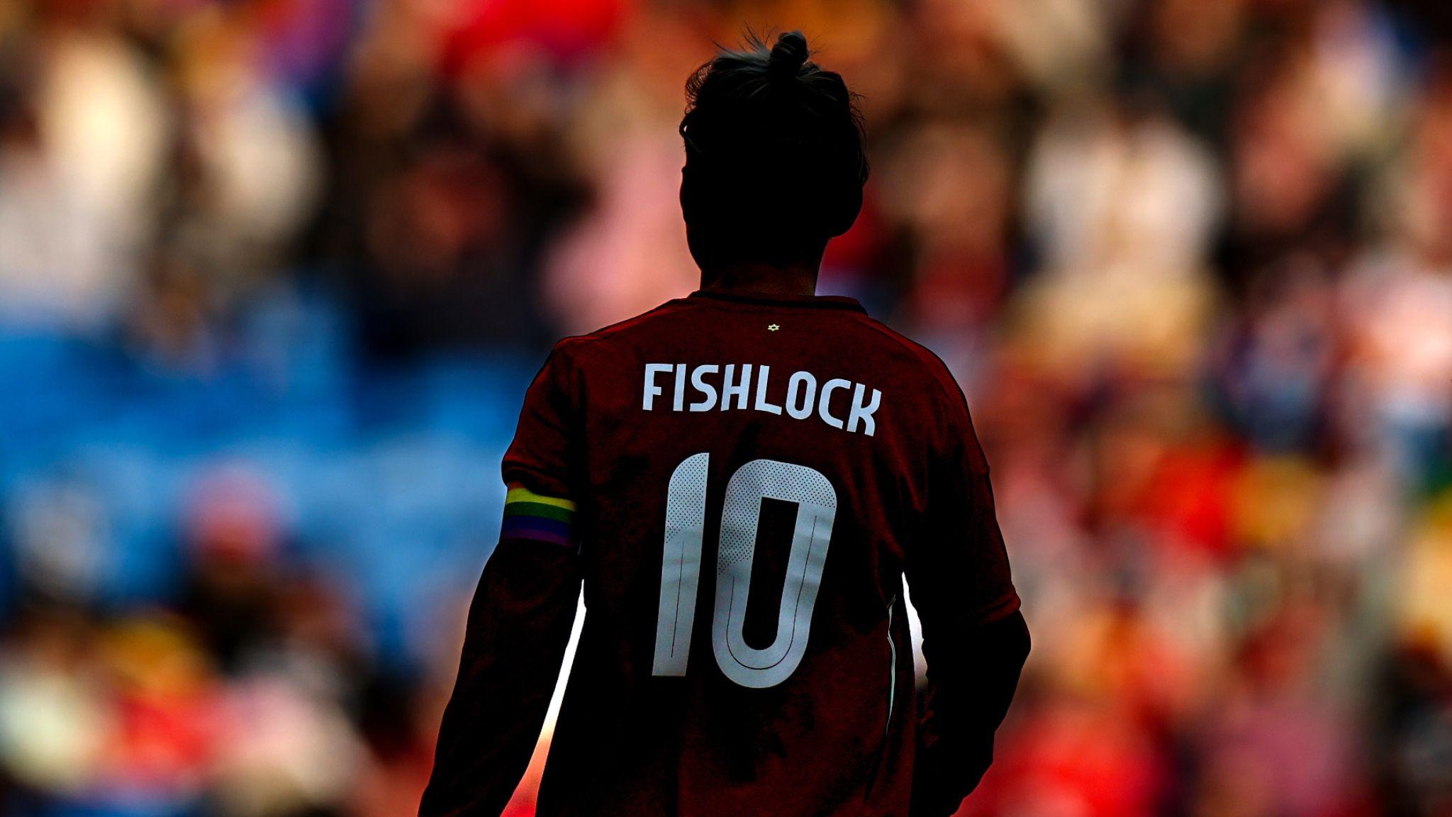 Jess Fishlock's back, showing her name and number, with the Wales crowd in the distance