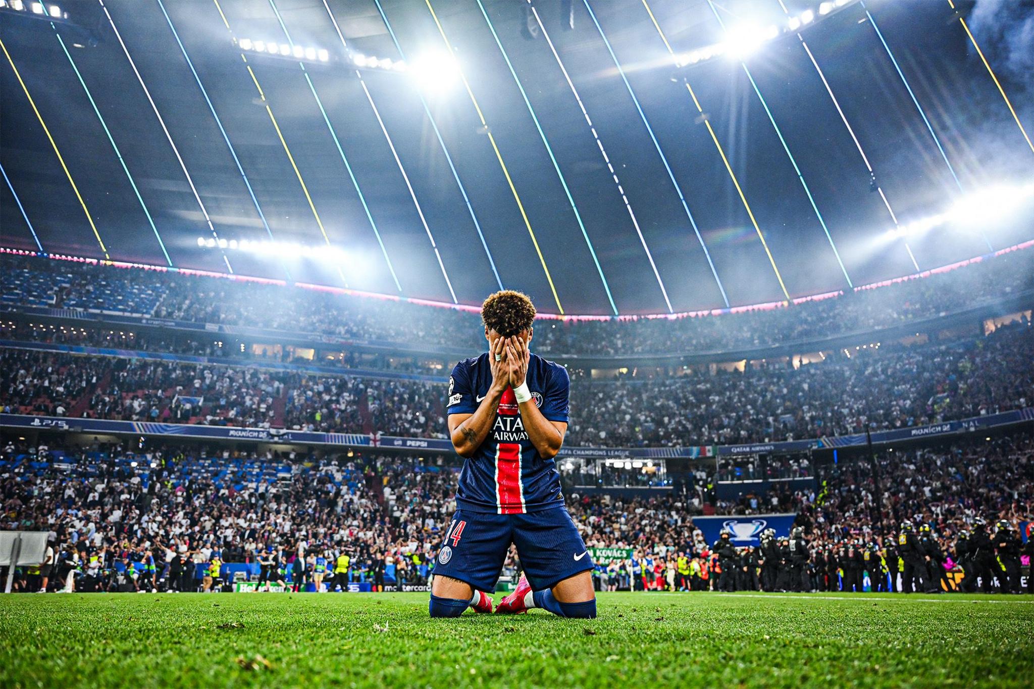 Paris Saint-Germain's Desire Doue appears emotional as he drops to his knees in celebration after his team's victory in the Champions League Final between Paris Saint-Germain and Inter Milan at Munich Football Arena in Munich, Germany. Photo by Michael Regan