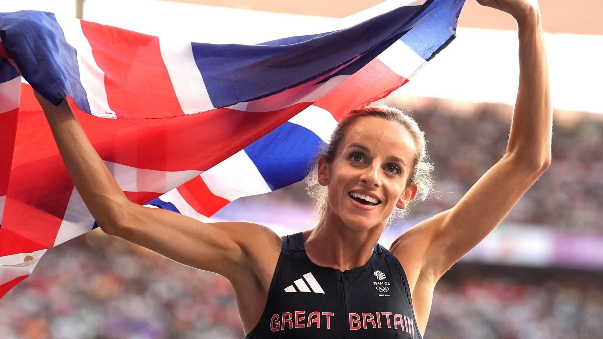 Georgia Hunter Bell holds a British flag after winning Olympic 1500m bronze