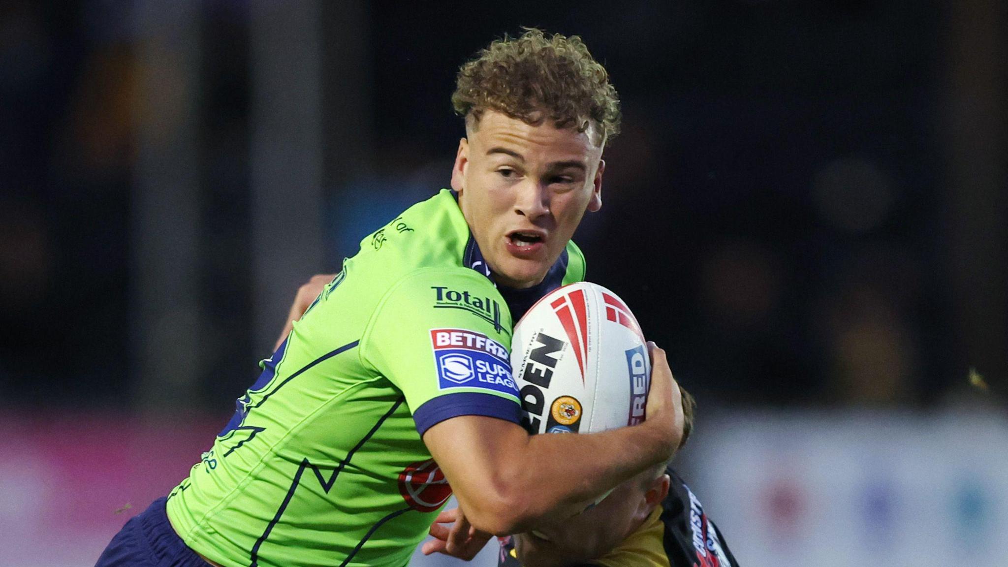 Cai Taylor-Wray with ball in hand on the attack for Warrington Wolves