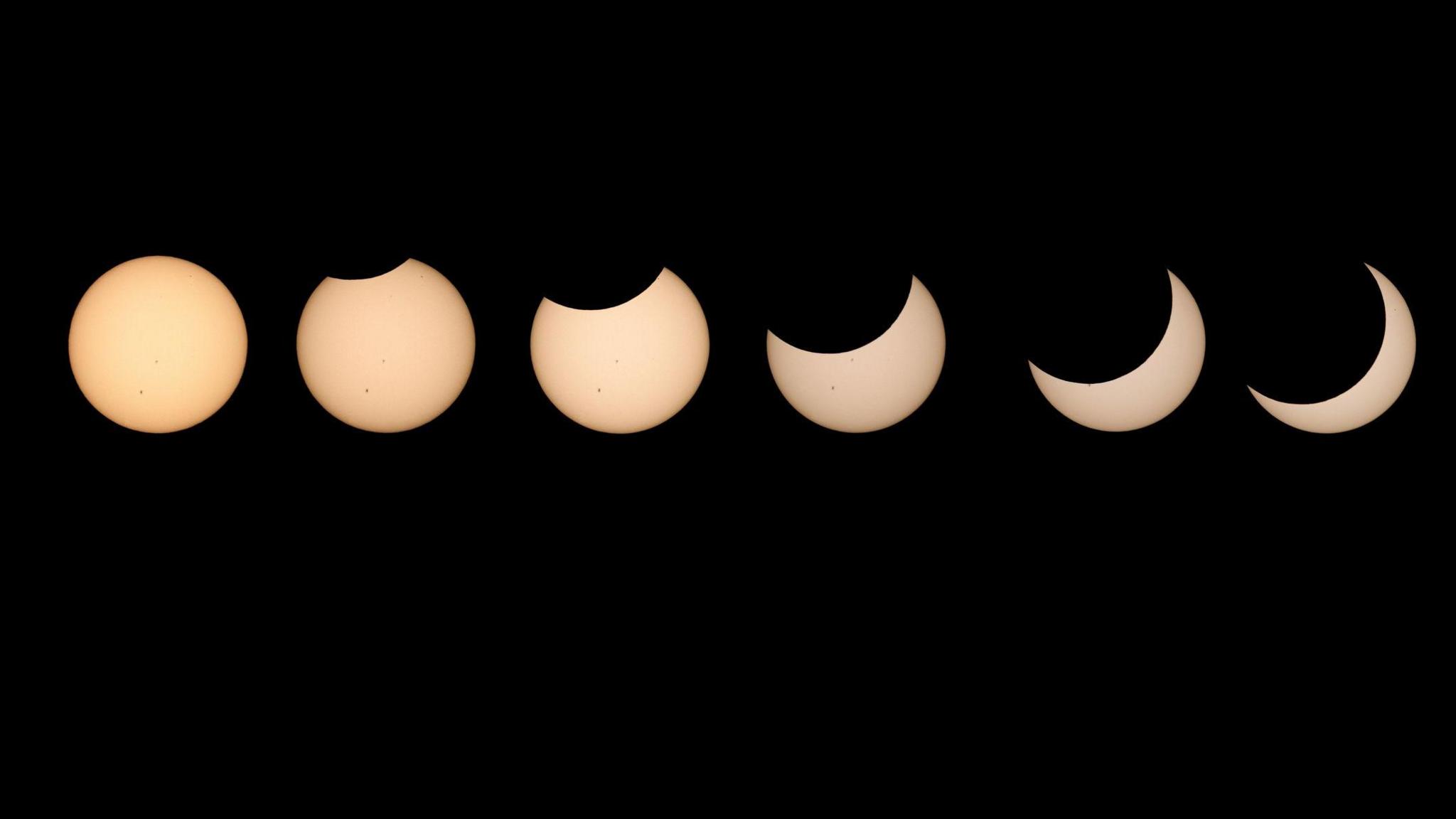 The progression of a solar eclipse - six yellow circles against a black backdrop slowly being more obscured.