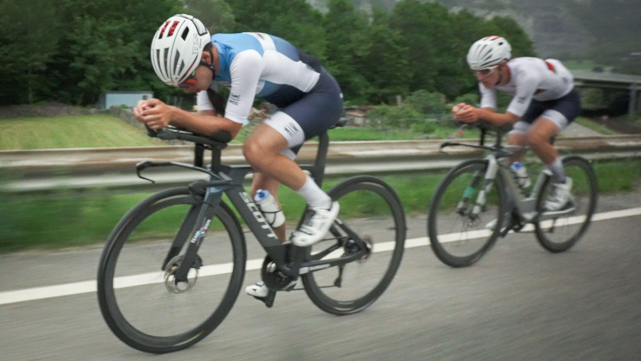 Yulduz and Fariba riding at speed along the side of a road