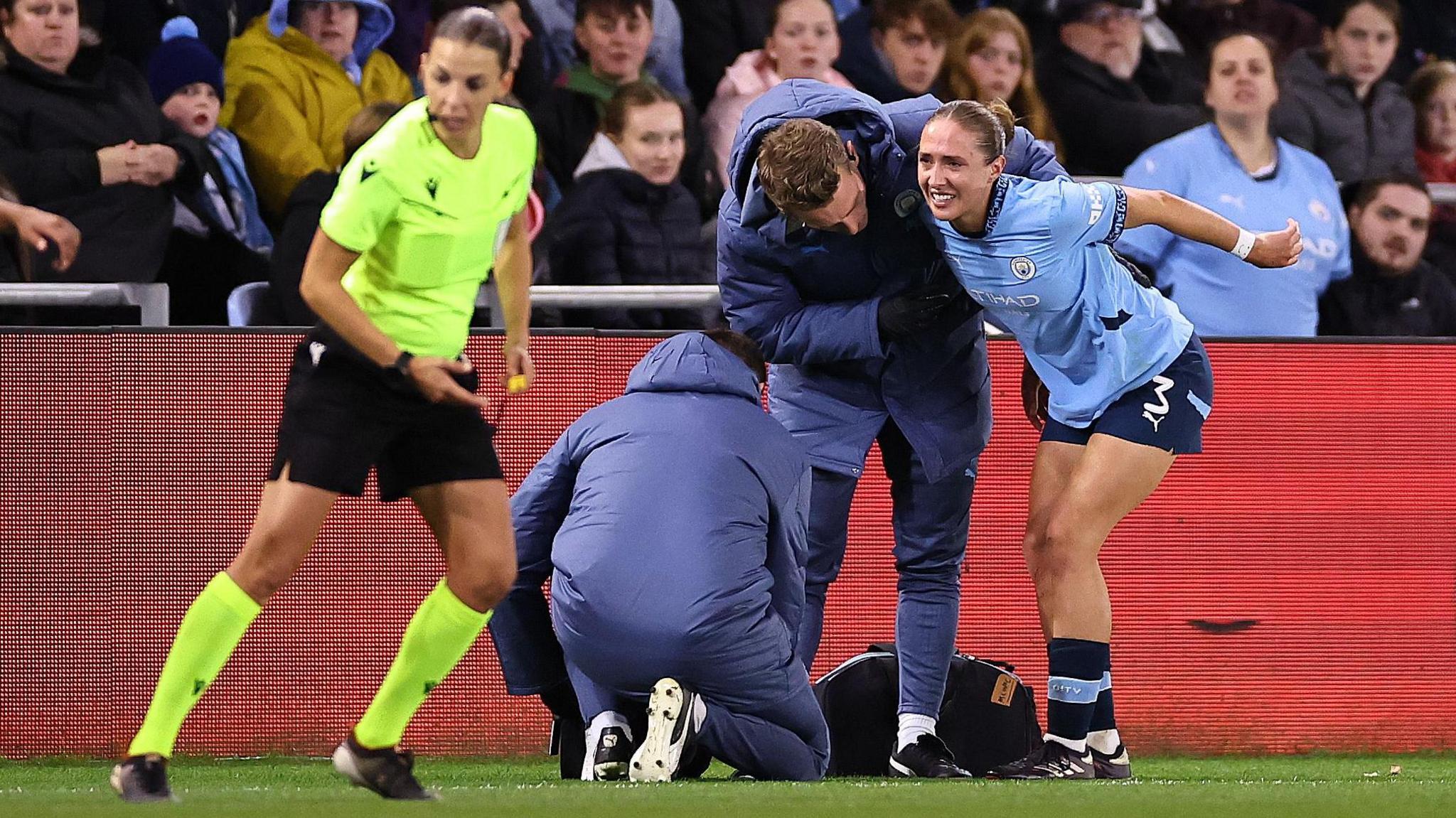 Naomi Layzell receives treatment from physios