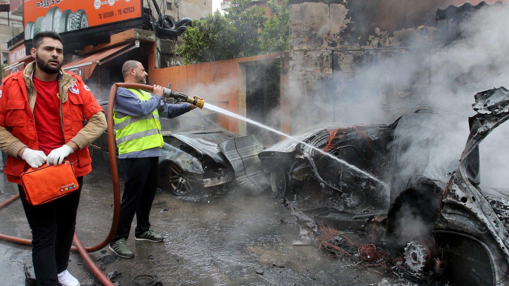 Lebanese fireman extinguishes fire in car of Palestinian Fatah official Fathi Zeidan following an explosion in southern port city of Sidon, Lebanon (12 April 2016)