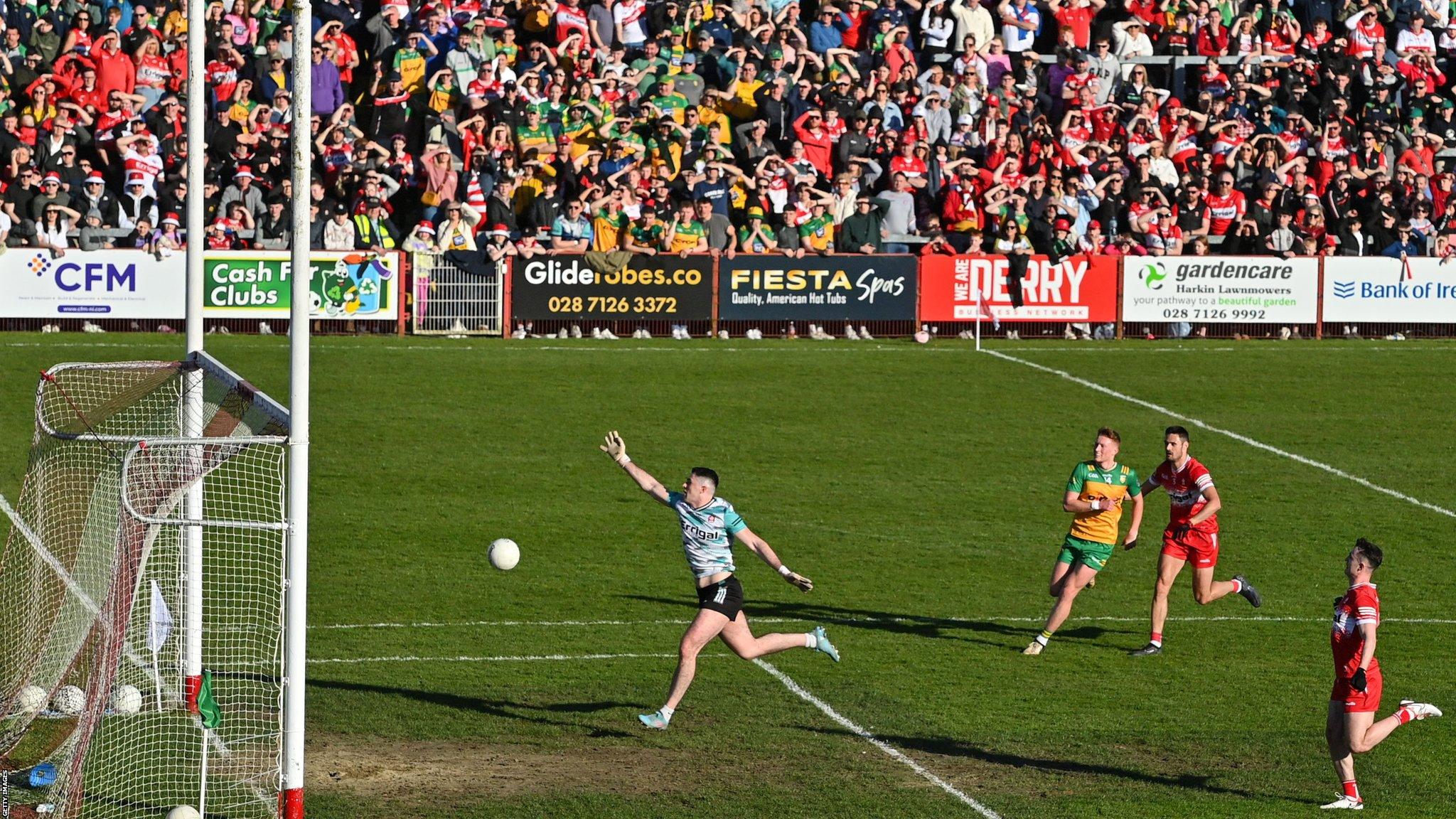 Derry 'keeper Odhran Lynch runs back towards his own goal as the ball is chipped over his head