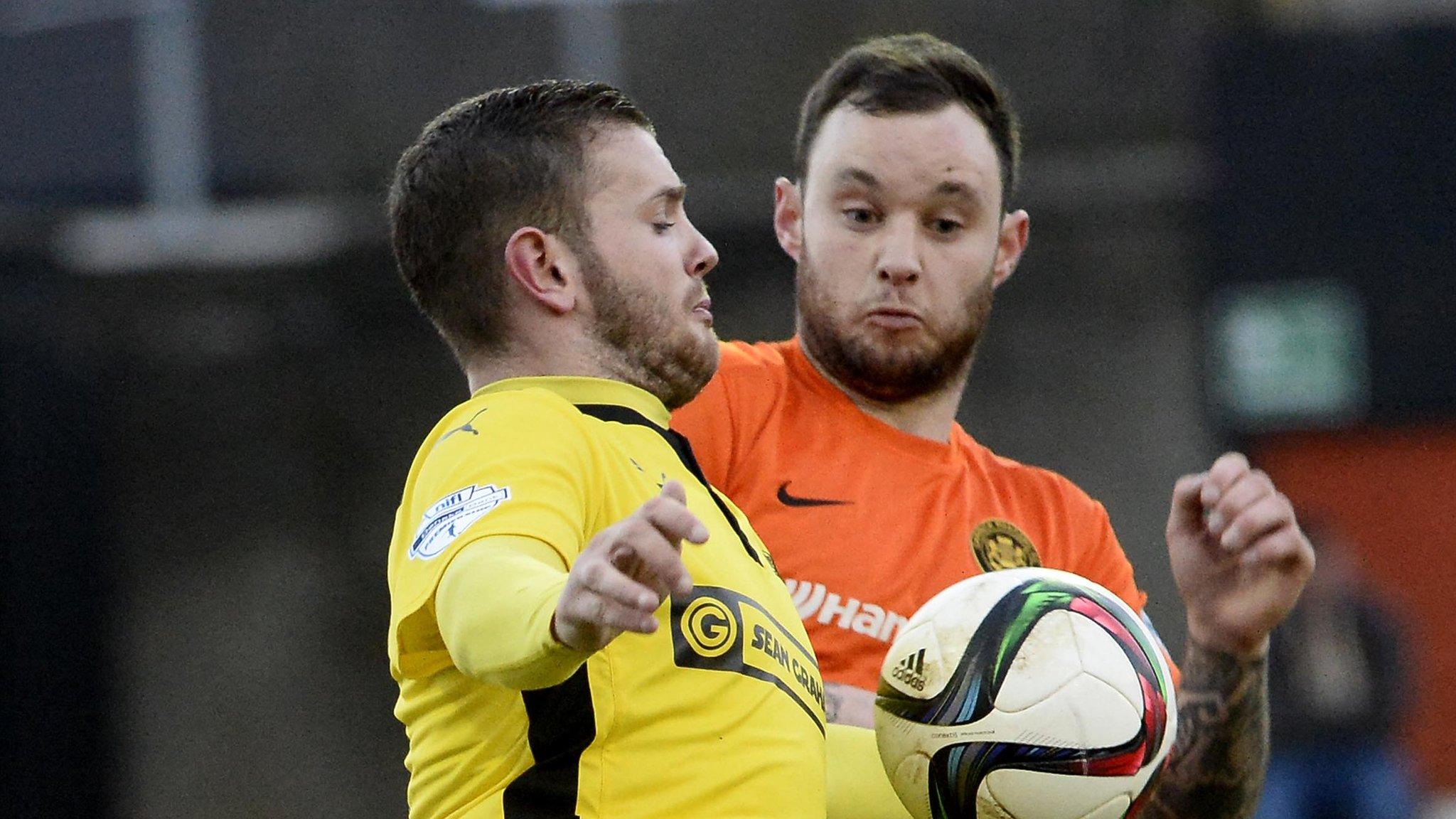 Cliftonville's Darren Murray competes against Andrew Doyle of Carrick Rangers