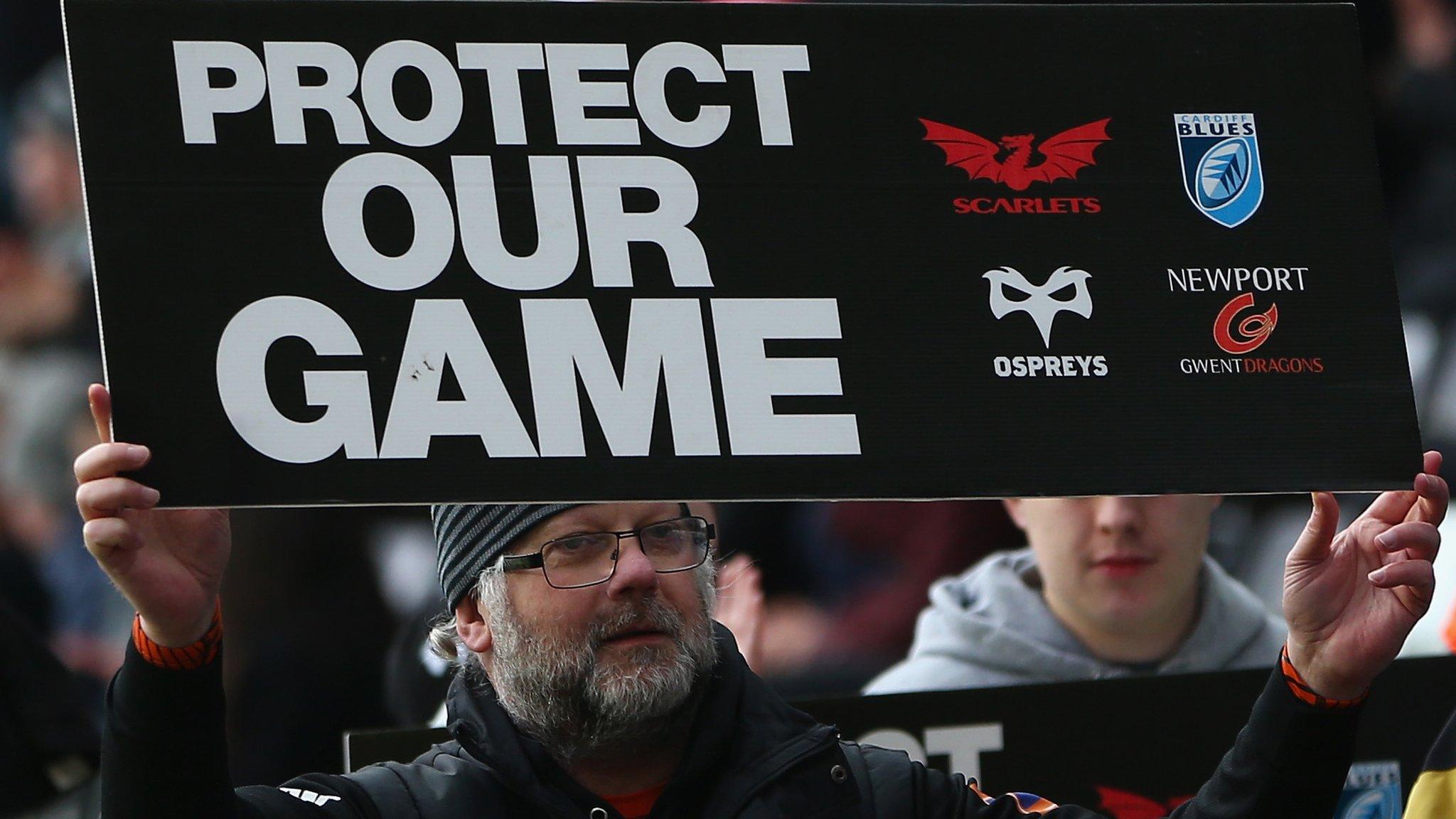 man with 'save our regions placard