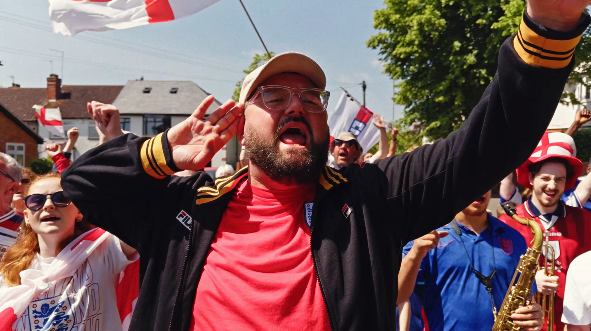 Maddox Jones leading a crowd of football supporters