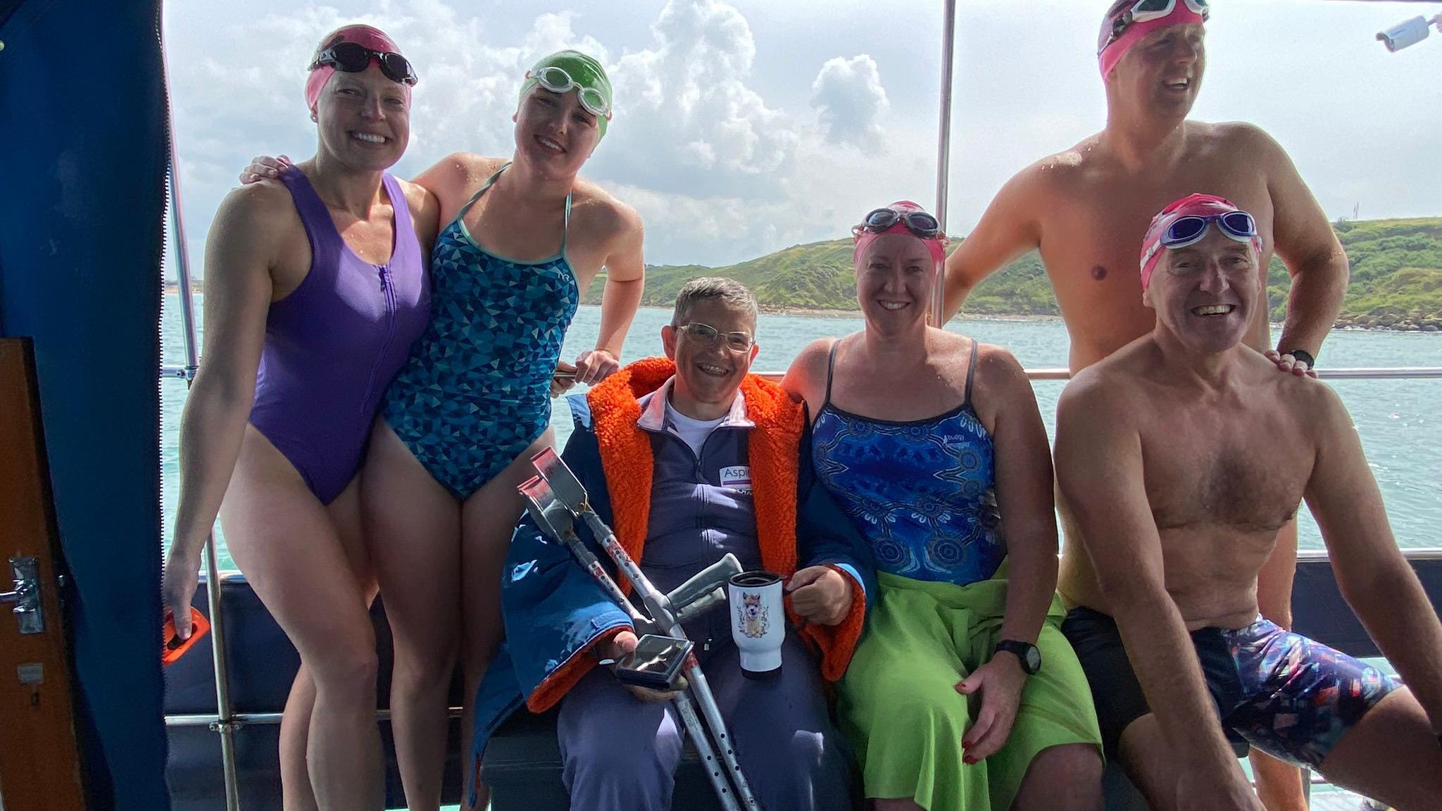 group of swimmers on boat