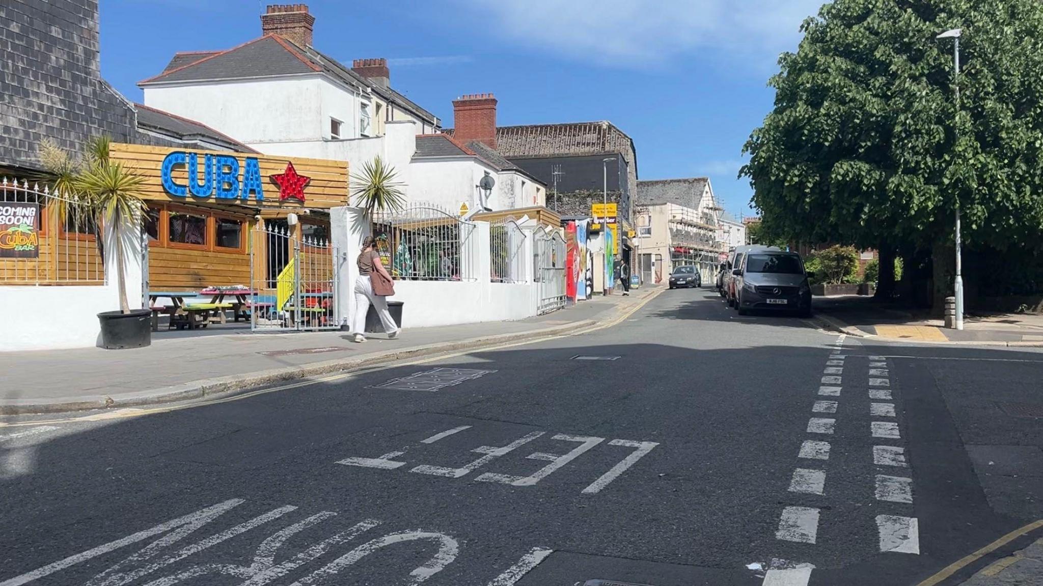 Gibbon Lane in Plymouth. There is a venue called 'CUBA' on the left of the image and cars parked along a street.