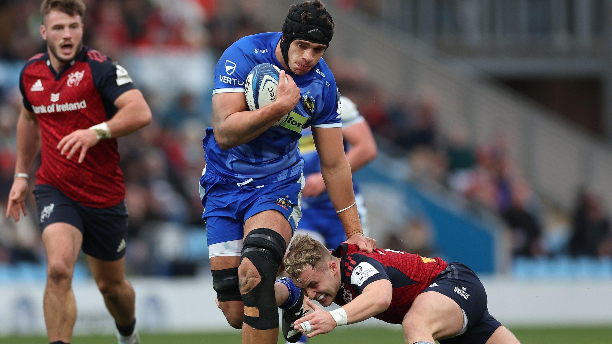 Dafydd Jenkins of Exeter holds off the challenge from Munster's Craig Casey 