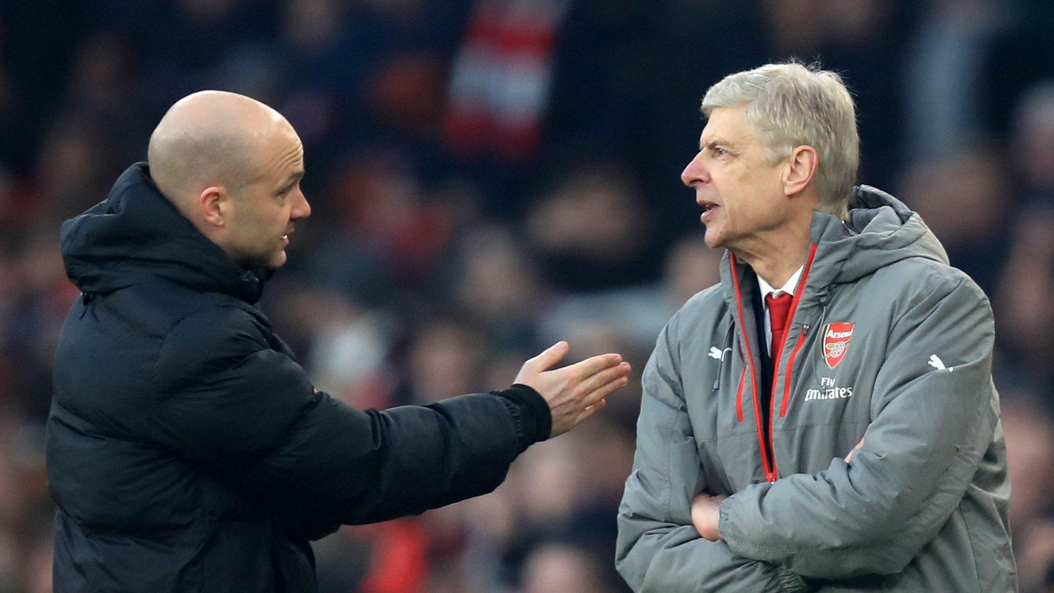 Arsenal manager Arsene Wenger (right) and fourth official Anthony Taylor