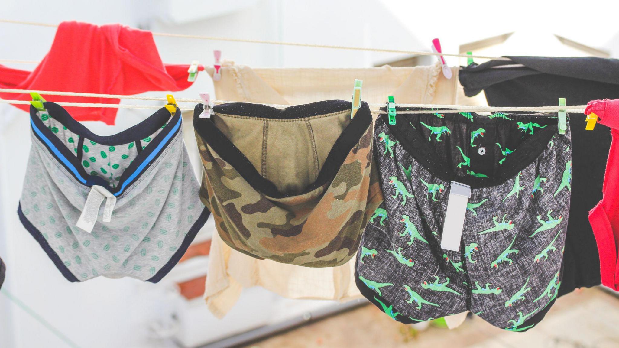 A generic picture of men's pants hanging on a washing line.