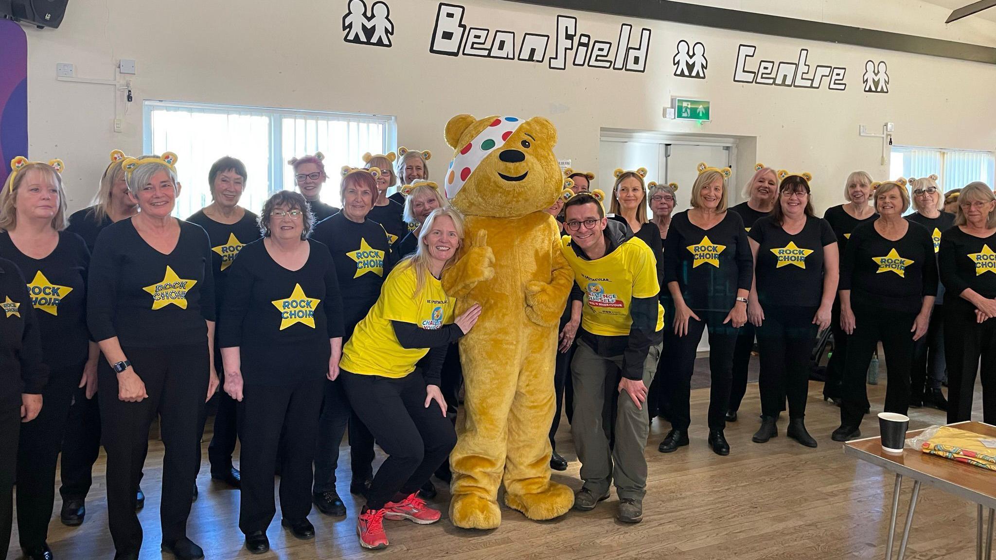 Annabel Amos, producer Tom Percival, and Pudsey with the Rock Choir