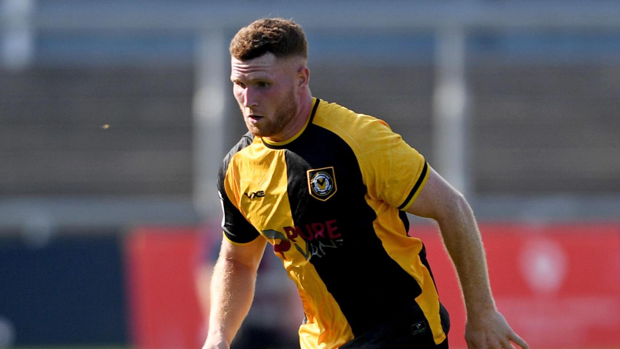 Newport County defender Lee Jenkins running with the ball at Rodney Parade