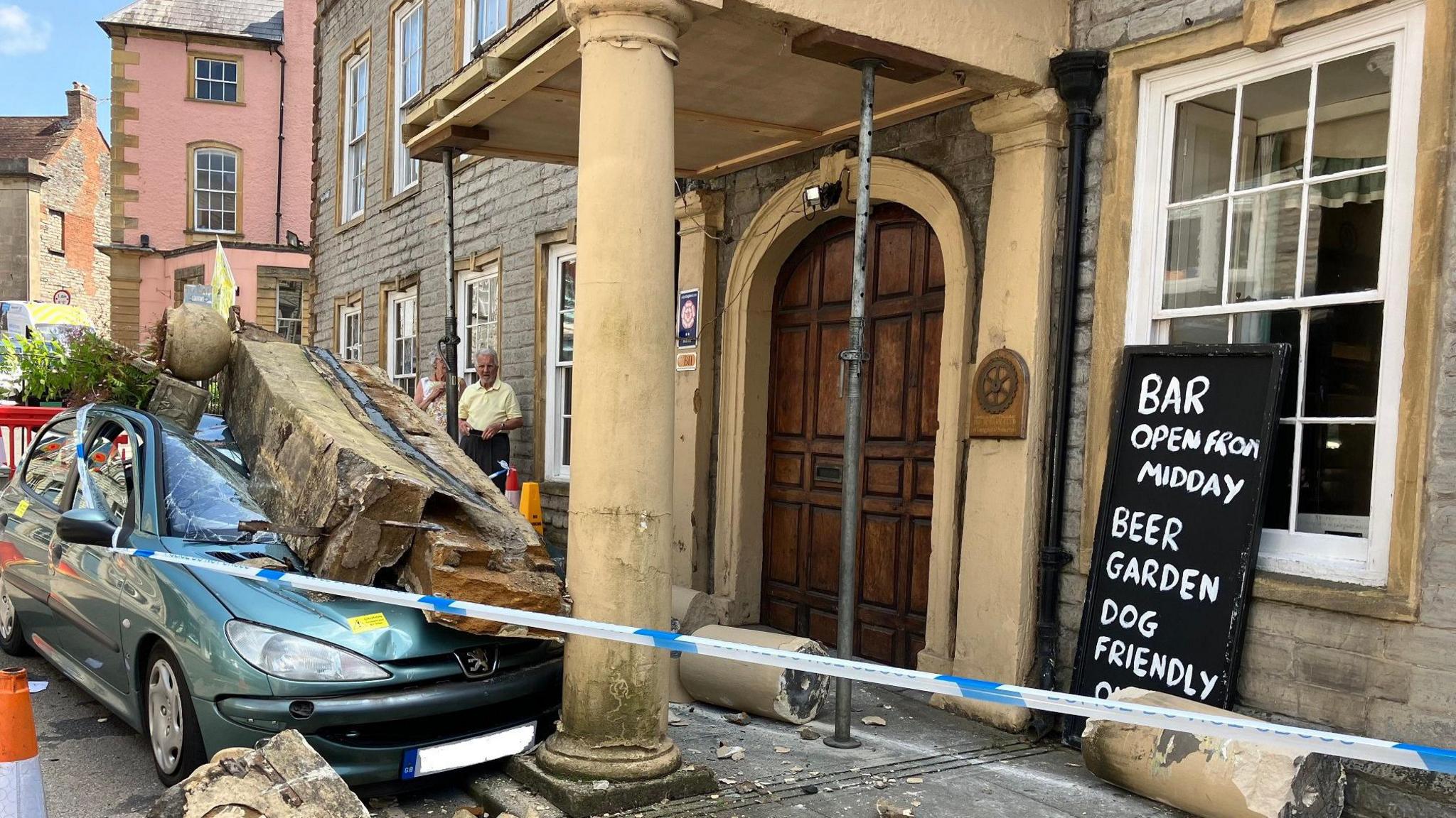 Car with smashed stones on top