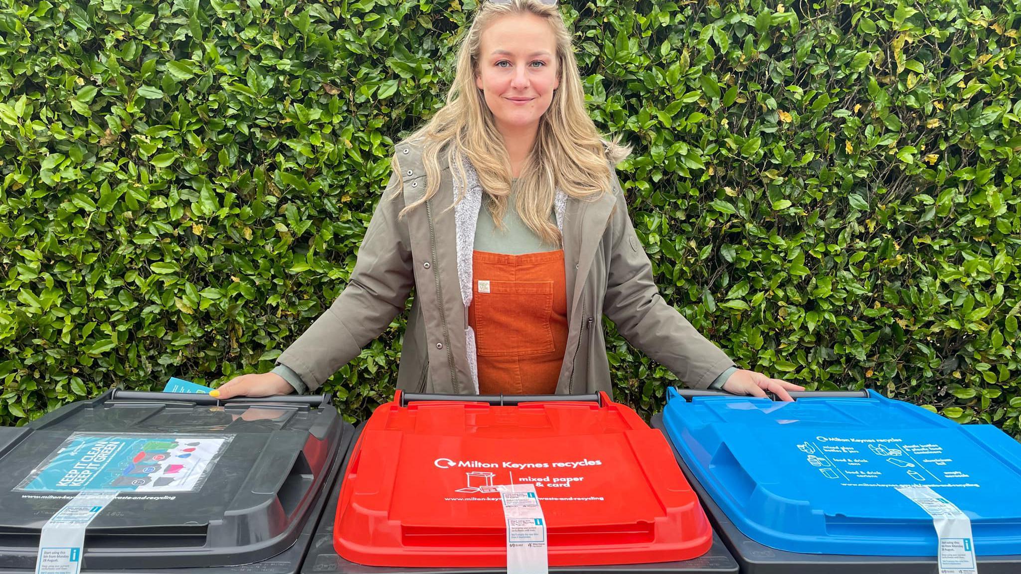 Councillor Lauren Townsend standing by three wheelie bins in Milton Keynes