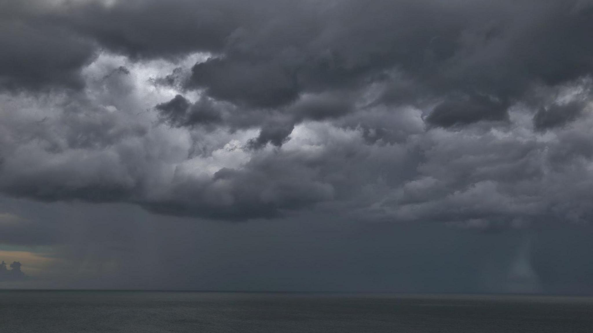 dark storm clouds over an ocean.